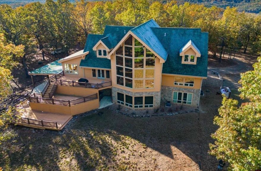 Gorgeous property all year around surrounded by Bulls Shoals Lake. This home provides plenty of living spaces with 6 large bedrooms and along with a large game room in the basement. Along with a very large living rom area that is open to the kitchen with the beautiful granite countertops. This home also provides a beautiful formal Dining Room with windows that surround the entire room giving you the feeling that you are out side while leaving you with plenary of room to have guest over for the holidays or any special occasion. This home also provides you with your own private boat dock to enjoy! This home is great to enjoy everything there is to do outdoors from hunting, fishing, kayaing or anything else that you want to do on the water!