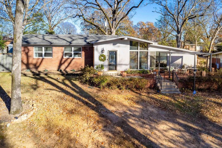 Adorable and immaculate Lakewood home with lake views and direct access to the water, tennis, ballpark, and the Old Mill. The vaulted living/dining area opens to an updated eat-in kitchen featuring custom cabinets, stainless steel appliances, and granite counters (2021). Spacious primary bedroom with two closets—wall previously removed, offering potential for a third bedroom. Beautifully renovated bathrooms (2019) include a double vanity, walk-in shower, and tub. A cozy den leads to a fenced yard and bricked patio with a new pergola (2025) overlooking Lake #3—perfect for entertaining. Wood-look ceramic tile throughout. Major updates include new A/C and ductwork (2019), electrical panel (2021), insulation, doors (interior and exterior), outlets, landscaping, and additional parking pad are all recent updates. Custom entertainment center included. Move-in ready with thoughtful upgrades in every space.