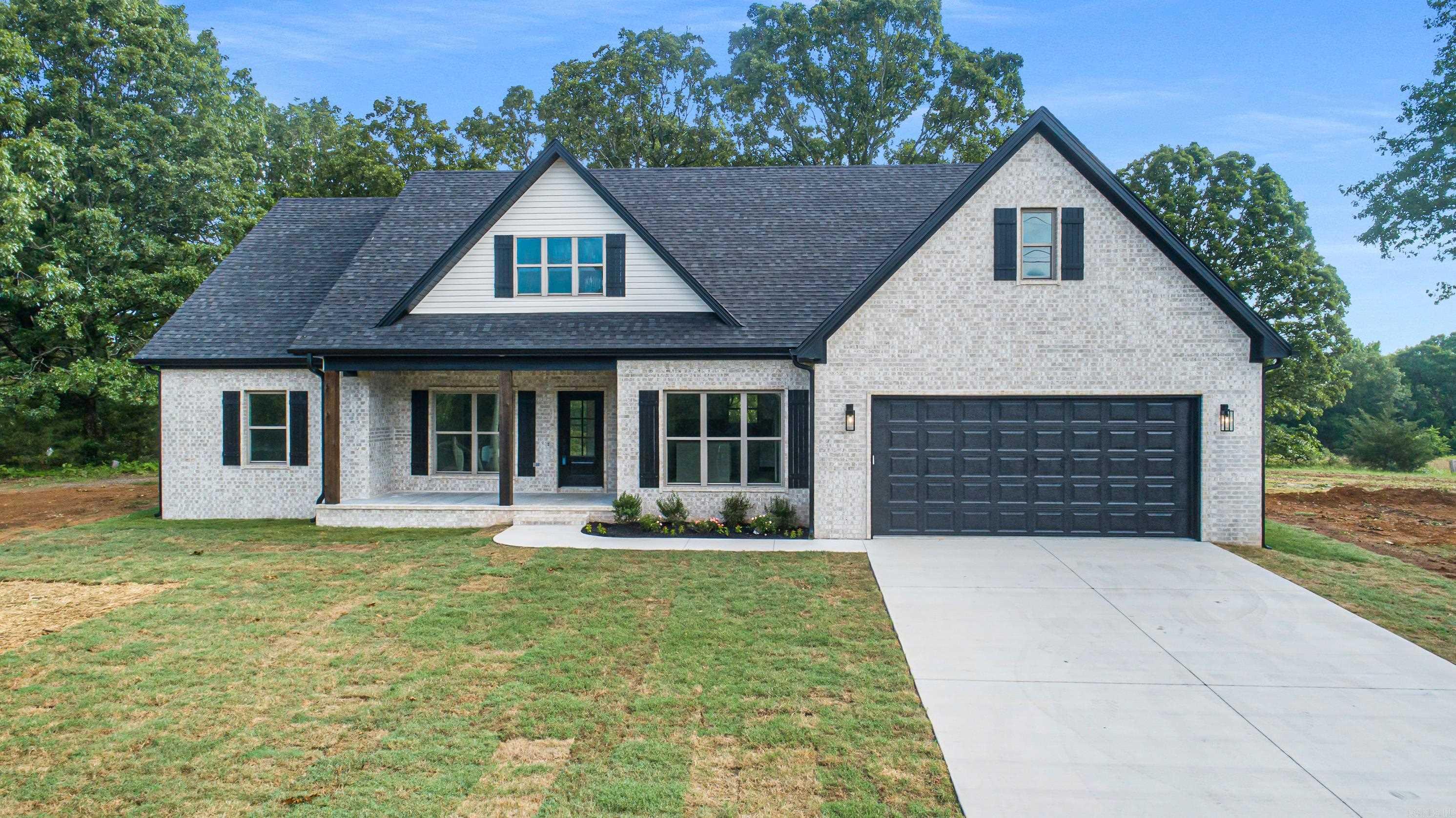 This stunning country residence is situated on 1.13 acres, offering ample space to breathe. This 1801 sq ft. 3/2 home features a beautifully appointed kitchen with a sliding barn door pantry. Living area is large and has ample windows to enjoy the peaceful country views. The laundry room is conveniently located next to the primary bedroom and can be accessed through the primary closet. The deep soaking tub provides a serene retreat, while the expansive back porch offers a private setting ideal for entertaining. The front porch was built for rocking chairs and sweet tea settings. Don't delay, come see what all the talk is about.
