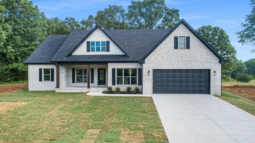 This stunning country residence is situated on 1.13 acres, offering ample space to breathe.  This 1801 sq ft. 3/2 home features a beautifully appointed kitchen with a sliding barn door pantry. Living area is large and has ample windows to enjoy the peaceful country views. The laundry room is conveniently located next to the primary bedroom and can be accessed through the primary closet.  The deep soaking tub provides a serene retreat, while the expansive back porch offers a private setting ideal for entertaining.  The front porch was built for rocking chairs and sweet tea settings. Don't delay, come see what all the talk is about.