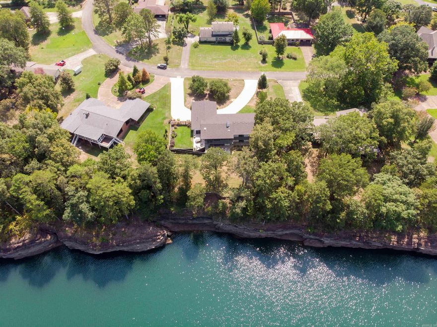 Lake front living at it's finest! This home sits on one of the best lake lots in town - level, close to the water with an open view and rare lake access.  No boat necessary when you can walk out the back door and float in deep water.  Enjoy lake views from nearly every room!  3 bedrooms, each with private bath and patio doors to the lakeside deck.  The indoor/outdoor dining porch opens to the upper patio and is water side.  Lower level has incredible views, a 2nd living area with Kitchenette, large guest room and full bath with shower. The house underwent an extensive renovation in 2020, taking the interior down to the studs and completely reconfiguring/rebuilding.  Improvements include: all new wiring & plumbing, foam insulation, central vac, tankless water heater, custom cabinetry and upgraded finishes throughout. Home boasts a chef's kitchen with integrated Thermador Refrigerator & Freezer, Thermador 6 burner gas range, Bosch wall ovens and Fischer Paykel dishwasher drawers.   The in town location is convenient to everything Heber has to offer, including all 3 marinas and the Little Red River.  This is a unique lakefront property that won't last long!