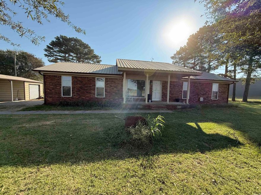 Investment Opportunity. Three bedrooms, two bath brick home on 0.75 Acres! Discover the potential of this 3-bedroom, 2-bathroom brick home nestled on a spacious 0.75-acre lot. Featuring a cozy woodburning fireplace for those chilly evenings, a one-car attached garage for convenience, and a two-car detached carport with a storage room offering extra storage or workshop space. Perfect for investors or DIY enthusiasts, this property is being sold as-is, giving you the chance to bring your vision to life and add your personal touch. Don't miss out on this rare opportunity to create value in this beautiful home! Great for a fix-and-flip or rental investment!