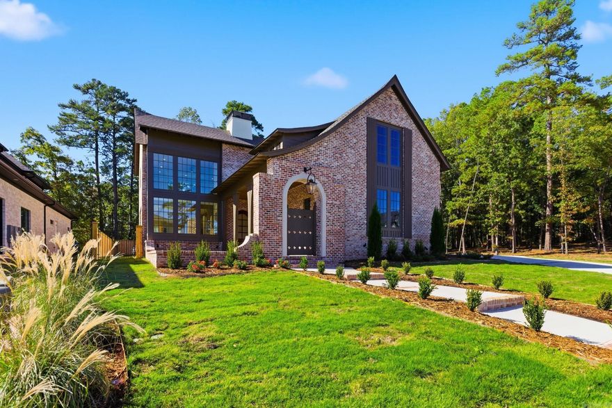 The Orle Residence is a French-inspired storybook manor reimagined for modern living. Crafted by HD Homes in collaboration with architect Salina Lambert, this architectural jewel rests within a gated and private Chenal community. Every detail has been meticulously curated, from custom wood and beam work with white oak beams to quartzite counters, honed Calacatta Vagli marble, and Bianca Rhino marble in the owner’s suite. Designer lighting from Visual Comfort illuminates artfully composed interiors, while the kitchen pairs bespoke wood finishes with Brizo Frank Lloyd Wright plumbing. The floor plan includes four bedrooms, four full baths, two half baths, a dedicated office, and a spacious media room, all flooded with natural light. Gas lanterns set a timeless tone, while the back porch extends entertaining with an outdoor kitchen and built-in heaters. Rare in both detail and refinement, this designer showcase masterpiece is truly worthy of Architectural Digest.
