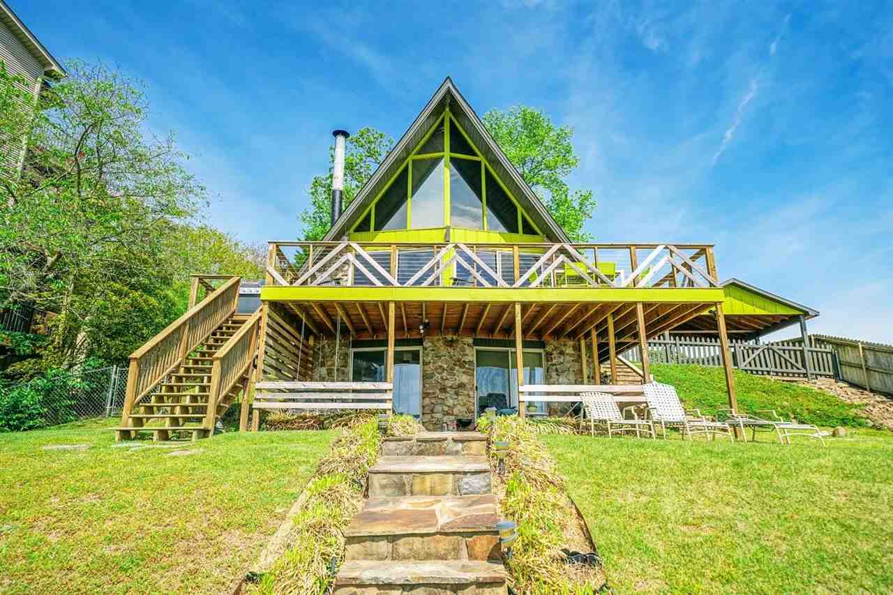 Epic Lake front views from this one of a kind Mid-Century A-Frame on prime lakefront. The rustic modern gem is conveniently located off Central Avenue on an island on main channel. The 3 level home consists of the 2 BR's, living space, 2.5 baths, deck and the Lower Studio, an efficiency w/ kitchenette, bathroom & patio.The private two-stall dock has lift & a water slide. Its a very popular unique vacation house currently used as two separate short term rentals. Don’t miss this great opportunity!!