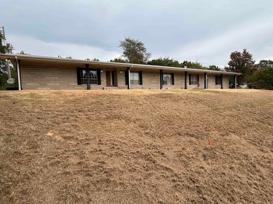 **** Sellers offering $15,000 in concessions!! ****   Large ledge stone ranch home sits on 8.59 acres with a spectacular view!!   Long driveway off main highway only 3.5 miles to downtown Morrilton and 20 minutes to downtown Conway.  Large kitchen with great potential! Large entertaining/kids room along with open great room off of kitchen. Full length sun room with hot tub, utility sink and space for lots of plants and projects. Whole house generator. Metal roof. Too much potential to mention it all!! Fenced in back yard for family pets and chicken coop ready for its new flock. Updating will be needed, flooring throughout required to be installed (is new and in boxes) and master bathroom will need complete remodel. Utility room will need new subfloor. Hardwood flooring included for main areas. House will be sold "AS-IS, WHERE-IS" as price reflects.  Can subdivide and sell lower portion of land and still have large beautiful yard with mature hardwoods and pines!   *** Agents - please see remarks ***