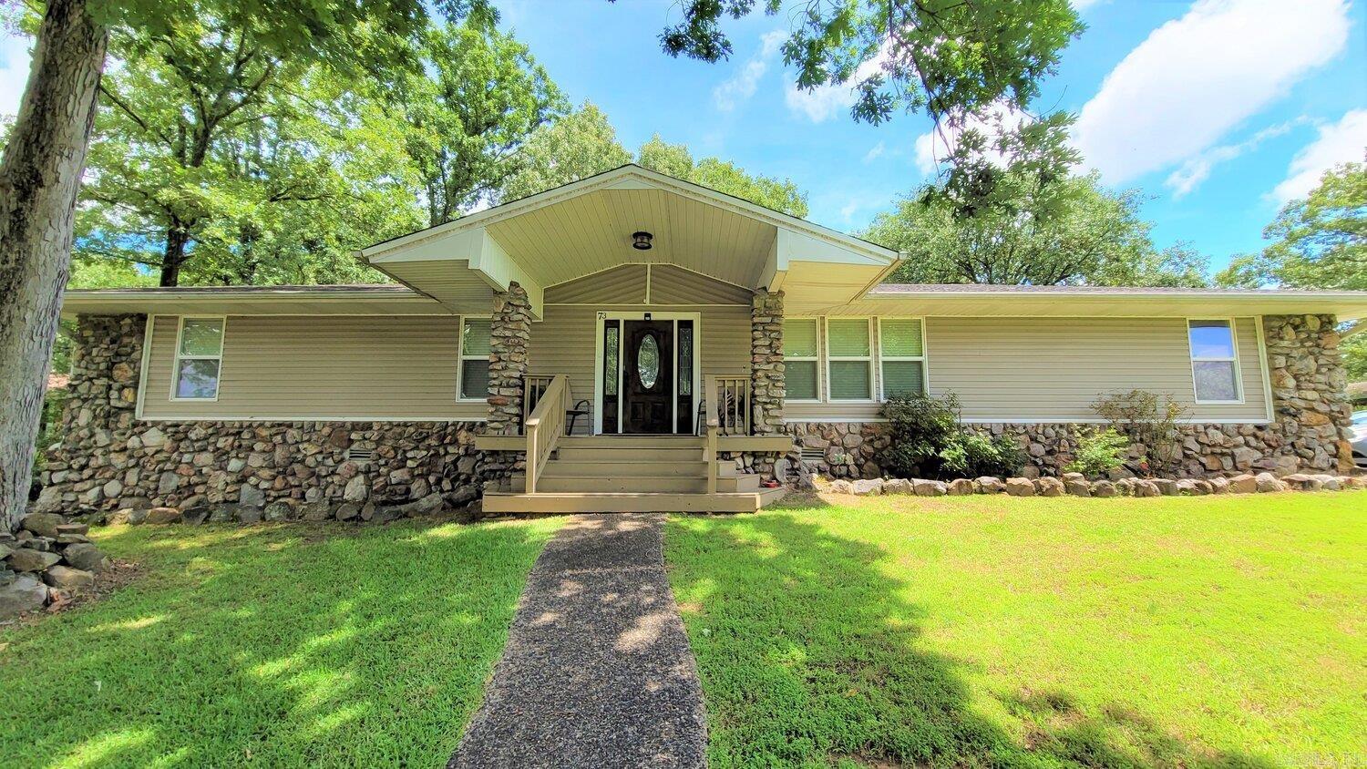 4 bedrooms, 3 full baths extensively remodeled 1 level. Very open floor plan features large kitchen with extra countertop space. Kitchen is open to the dining area and living areas. Fireplace. Utility room with lots of extra storage. Front room can be an office or formal living area. Side loading 2 car garage with additional storage room. Private deck in perfect for enjoying the fully fenced back yard. There is also a storage building. All on a corner lot! A view of Indianhead lake from the front porch. Indianhead lake is great for fishing, boating, canoeing, and kayaking. Launch area provides a place to bank fish of picnic.