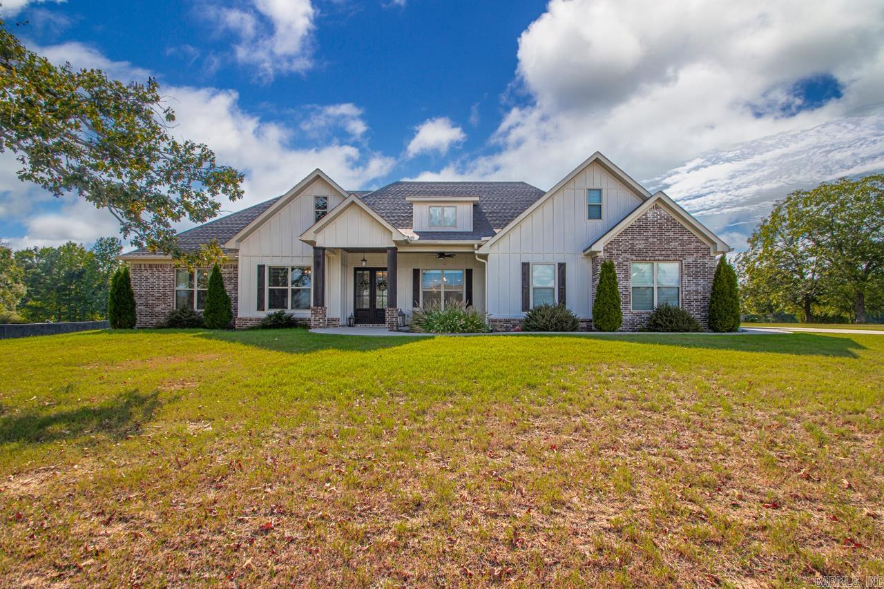 Boasting tons of curb appeal, this home sits on a one-acre lot in the Vineyards! 4 bedrooms and 2 1/2 baths all on one level! Plus a huge bonus room upstairs (could be a 5th bedroom)! Beautiful brand new hardwoods throughout - no carpet! The great room features a wall of windows with custom shades, cathedral ceilings, a gas log fireplace, and custom built-ins on either side of the fireplace. The eat-in kitchen is open to the great room and features a large island, gas stove, granite countertops and tons of cabinet space! The formal dining room is perfect with plantation shutters and a tongue in groove stained ceiling! The primary bedroom is apart from the other bedrooms and features a custom tiled shower and a soaker tub. The laundry room and mud room area are conveniently located near the primary bedroom/and the two primary closets. Outside, there is a large covered patio and tons of space! Plenty of room for a future pool or shop! 3 Car Garage!!