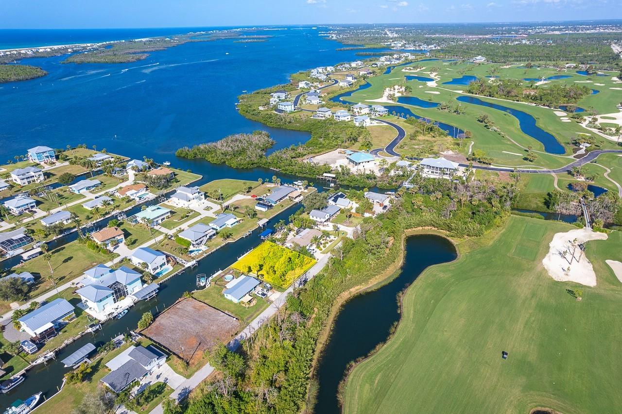 Your dream home awaits on this excellent buildable lot with direct boating access to the Gulf via Stump Pass, Gasparilla Pass, and the Boca Grande Channel. Additional privacy is provided in thanks to Lemon Bay Golf Club bordering the East side of Raymond St. For those days you would prefer a drive to the beach in lieu of beaching the boat, several areas beaches including Englewood, Stump Pass, Middle and Manasota Key Beaches, as well as Boca Grande are just a few minutes away. This lot is suitable for one level as well as multi-level designs so bring your imagination to your builder's design consultation. The composite dock and concrete seawall were replaced in 2016, just add a lift when you're ready! Plus, the channel is deep enough for your Deep V hulls too!