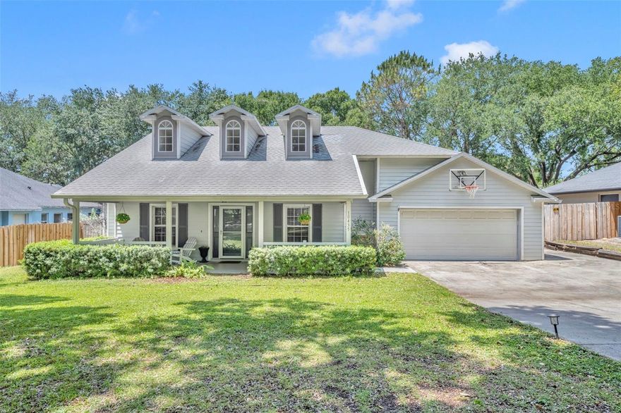 One or more photo(s) has been virtually staged. Welcome to this charming home in the desirable Sawmill subdivision of Clermont. The home features a long driveway and an inviting covered front porch that sets the tone for its warm curb appeal. Inside, you’ll find a split floor plan and luxury vinyl flooring with a wood-like finish throughout, offering both style and functionality. On the left side, there are three secondary bedrooms including a versatile front bedroom with double-door entry and a walk-in closet, perfect for a home office. At the end of the hallway is a full bathroom that serves the three bedrooms and features an updated quartz vanity and a tub/shower combo. The main living area includes a formal dining room area and leads into a spacious living room that flows seamlessly into the kitchen. The kitchen is equipped with stainless steel appliances, an induction oven, range hood, ample cabinet and counter space and a cozy breakfast nook just off the kitchen. The private primary suite features French doors opening to the screened lanai and offers views of the expansive backyard. The ensuite bathroom includes dual updated vanities, a soaking tub, walk-in shower and a large walk-in closet. Step outside to enjoy the screened lanai is perfect for entertaining. It includes a generous covered space and a charming wood shiplap wall. The fully fenced backyard offers plenty of room to play or relax, complete with a thoughtfully designed patio area and a custom doghouse that mirrors the look of the home. Conveniently located near shopping and numerous restaurants. Enjoy this beautiful home, nestled in a peaceful neighborhood with breathtaking lake views at the end of the street. Don’t miss the opportunity to make this charming home your own.