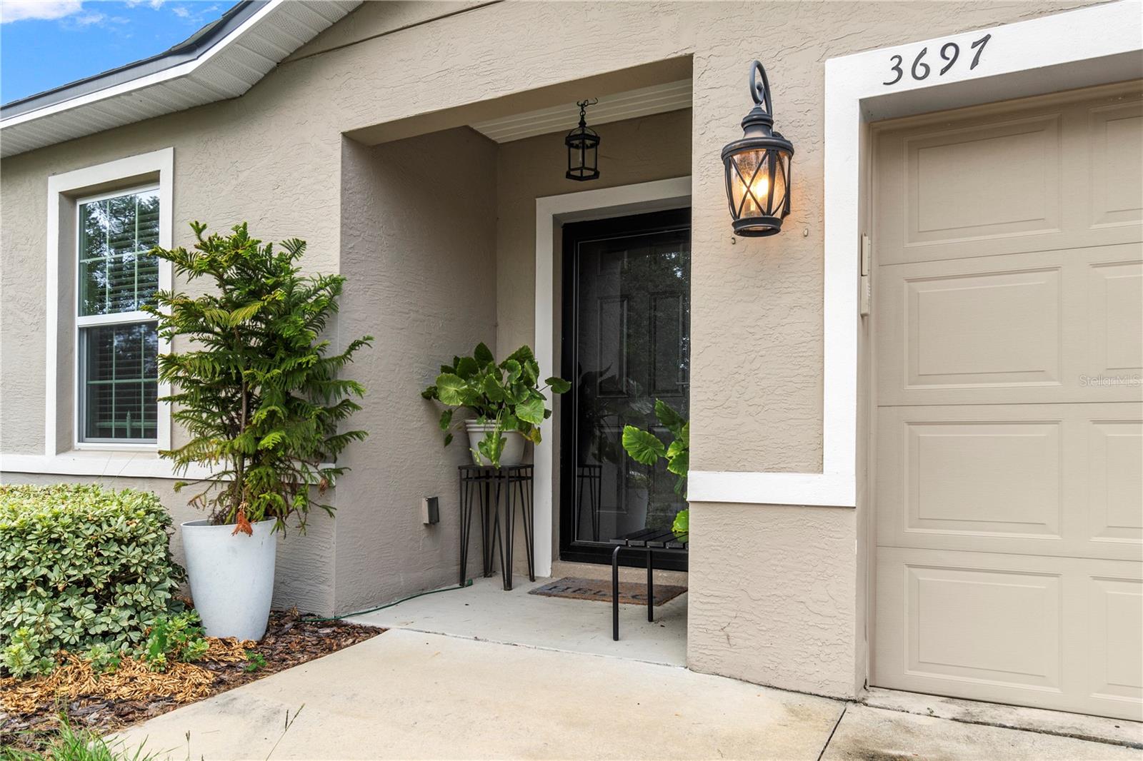 Welcome to 3697 SW 128th Place, a stunning residence nestled in the heart of beautiful Ocala, Florida. Built in 2020, this home boasts a modern and open floor plan, perfect for both relaxation and entertaining. The interior is beautifully decorated, featuring elegant granite countertops that add a touch of luxury to the space.
The owner has thoughtfully enhanced the outdoor living experience with a remote-controlled retractable awning on the back porch, complete with lighting, creating an ideal setting for gatherings and relaxation. The property is nicely landscaped, offering a serene and inviting atmosphere.
The primary suite is a true retreat, featuring a spa-like bathroom that promises relaxation and comfort. The wonderful split floor plan ensures privacy and ample space for everyone in the household.
Additionally, the home includes a spacious two-car garage equipped with built-in storage, providing convenience and organization. This property is a perfect blend of style, functionality, and comfort, ready to welcome its new owners.