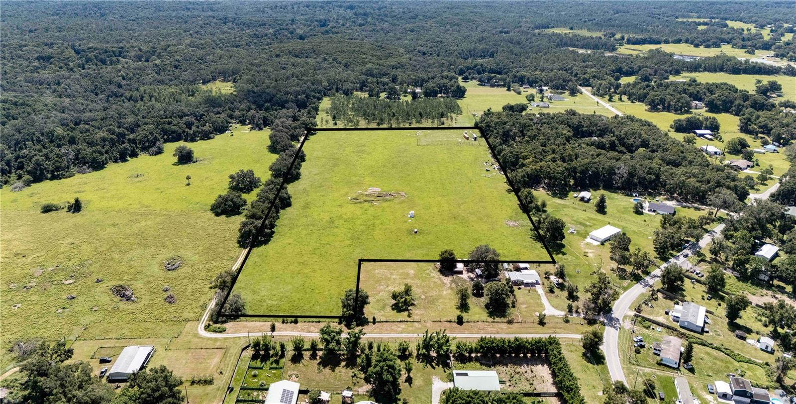 Escape the hustle and bustle and embrace the endless opportunities - your scenic 18 acre paradise awaits! This incredible property offers the perfect opportunity for those craving space, freedom, and a rural lifestyle. Whether you're dreaming of a private country retreat, farm life, or a family compound, this land delivers the ideal canvas! Zoned AC and located outside of the flood zone, the property allows for agricultural animals and farming- so bring the horses, cows, goats, or garden plans! You have the flexibility to build a custom single-family home or a manufactured home to suit your vision. A well and electric pole are already in place. The land is fully fenced and gated, offering peace of mind and easy access. Surrounded by the natural beauty of Florida's countryside, this is the kind of land that you can truly turn into your own forever home. Schedule your showing today and start building the lifestyle you've been waiting for!