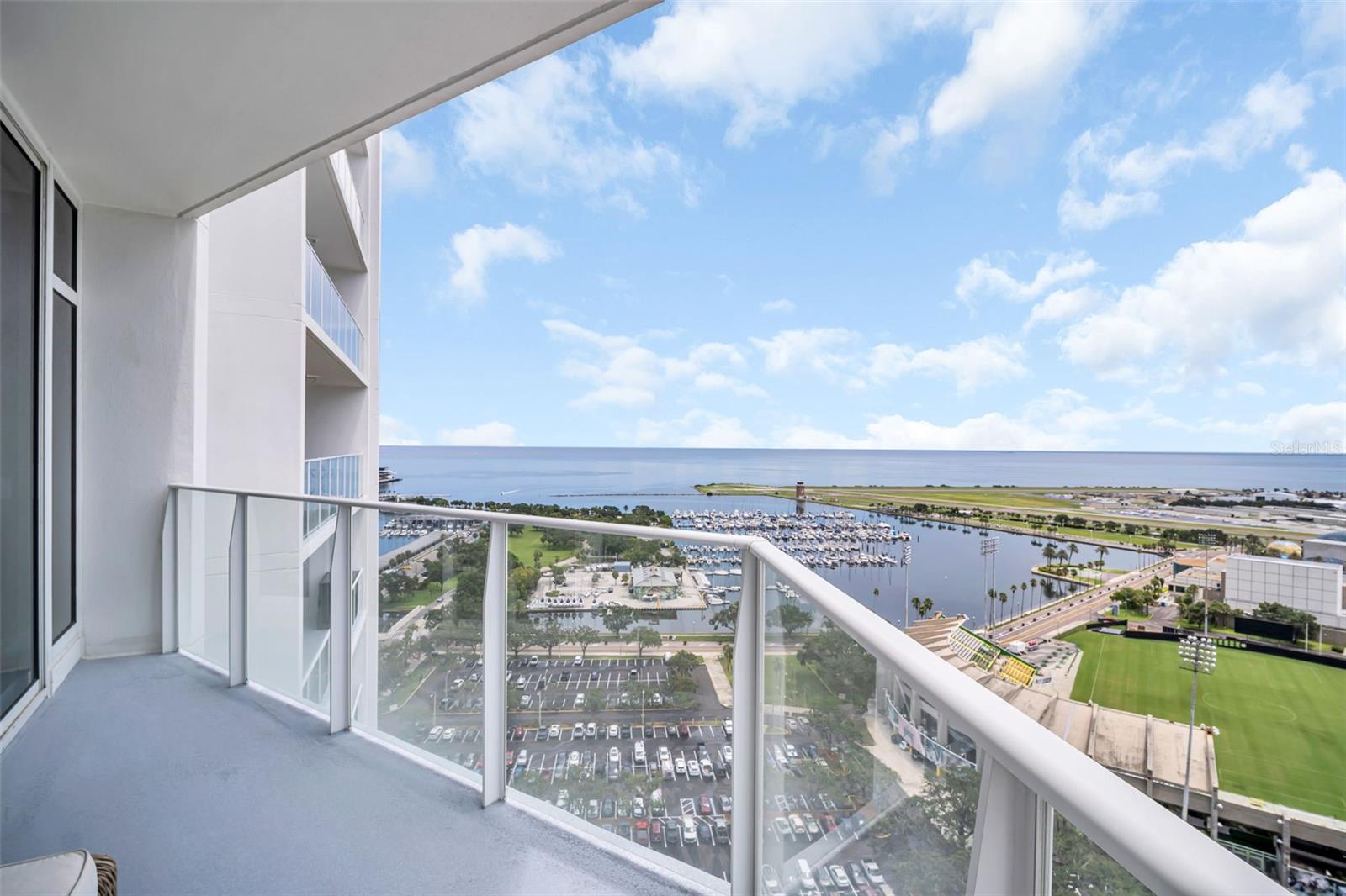 Rare, water-view 2-bedroom, 2-bath luxury condo in the highly coveted Signature Place, offering 1,269 square feet of intelligently designed living space with minimal wasted space and one of the few units featuring a dedicated laundry room. South-southeast facing, this residence is flooded with beautiful morning light while avoiding the afternoon heat, and boasts breathtaking panoramic views of the Saturday Morning Market, Al Lang Rowdies Stadium, downtown St. Petersburg, the sparkling waters of Tampa Bay, andplanes taking off and landing at Albert Whitted Airport, along with spectacular sights of the annual St. Petersburg Grand Prix. Fully remodeled in August 2018, the condo
showcases Italian wood and glass interior doors, sleek tile flooring throughout, and upgraded designer lighting, creating a modern, sophisticated ambiance. The second bedroom features a Murphy bed with a real queen mattress, offering flexibility for guests or a home office. Additional perks include two dedicated parking spaces and a full-size climate-controlled storage unit downstairs (approx. 4’ wide x 6’ deep x 8’ tall) for maximum convenience. Signature Place provides a resort-style lifestyle with 24/7 concierge service, a grand lobby, elegant clubhouse rooms, state-of-the-art fitness center, a heated infinity-edge pool and spa and outdoor grills. Perfectly situated in the
heart of downtown St. Petersburg, this condo places you steps from world-class dining, boutique shopping, grocery stores, museums, the Pinellas Trail, sports arenas, and scenic waterfront parks—truly a front-row seat to the best of city living and coastal charm.
Surveillance equipment has been installed or is located on the Property. Entry upon the Property is deemed consent to any recording, whether audio and/or video.