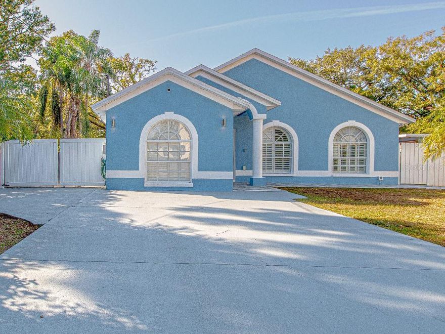 Stunning fully renovated home completed in 2021, offering modern design, high-quality finishes, and exceptional energy efficiency. This beautiful single-story property was rebuilt from the inside out—new plumbing, new electrical, new air conditioning system, new insulation, new drywall, and updated finishes throughout—providing the comfort and reliability of a newer home in an established Tampa neighborhood.

The open floorplan features sleek porcelain flooring throughout, high ceilings, and abundant natural light. The spacious living and dining areas flow seamlessly into the upgraded kitchen, complete with stone counters, stainless steel appliances, and a convenient eat-in space.

The primary suite is a true retreat, featuring a beautifully designed walk-in closet —a spacious, organized, and elegant dressing space that feels like every woman’s dream closet. Thoughtfully planned shelving, storage, and layout make it both luxurious and functional.

All additional bedrooms offer excellent flexibility for family, guests, or a home office.

One of the home’s standout upgrades is the spray foam insulation, which dramatically improves energy efficiency, helps maintain steady indoor temperatures, reduces outside noise, and lowers monthly utility costs—an exceptional feature for Florida’s climate.

Step outside to your own private entertainment oasis. The expansive covered patio includes a fully equipped outdoor kitchen featuring a built-in microwave, cooktop, oven, and generous counter space—perfect for gatherings, outdoor dining, and year-round entertaining. The large backyard provides even more room to relax and enjoy the Florida lifestyle.

Situated on a 7,350 sq ft lot in a quiet, central Tampa location, this home offers convenience to major highways, shopping, dining, and schools. Move-in ready and meticulously updated, this property is a rare opportunity to own a truly modernized, stylish, and highly upgraded home.