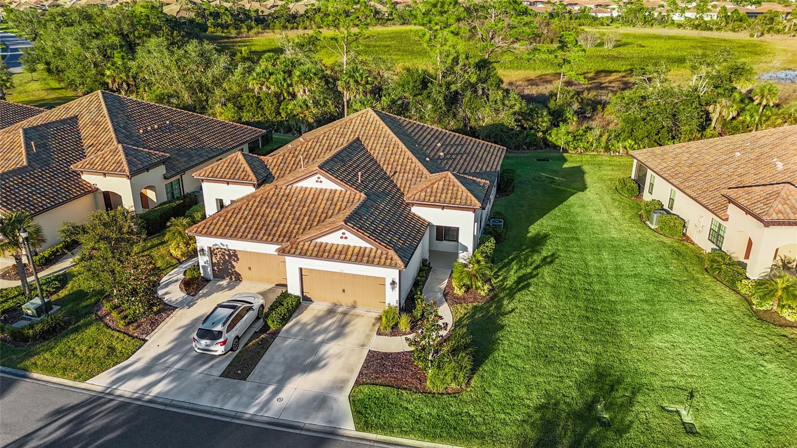 One or more photo(s) has been virtually staged. Florida living at it's finest, with NO CDD fees! This gorgeous villa is priced to sell and move-in ready located in the sought after resort-style, gated community of Vicenza. Built in 2021, this 2-bedroom, 2-bath home with a versatile den/office, and 2-car garage, blends modern coastal elegance with peaceful preserve views. From the inviting covered front porch to the screened lanai overlooking a lush nature preserve, this home is designed for both relaxation and entertainment. You'll love the high ceilings, large-format tile flooring, and freshly painted interiors in warm grays and crisp whites, all highlighted by designer light fixtures and contemporary ceiling fans.
The heart of the home is the open-concept great room, anchored by a stunning kitchen featuring quartz countertops, light gray cabinetry, subway tile backsplash in a herringbone pattern, stainless steel appliances including a gas range, and a spacious island perfect for casual dining or entertaining. Large sliders allow natural light to flood the space and provide seamless access to the northeast-facing lanai, ideal for enjoying morning coffee without the afternoon heat.
The private primary suite is tucked at the rear and includes dual vanities and a spa-style walk-in shower, while the guest bedroom and full bath are thoughtfully separated for privacy. Located on a quiet, low-traffic street just a short stroll from the community amenity center, you’ll enjoy access to a resort-style heated pool and spa, pickleball and bocce courts, two dog parks, clubhouse, and nature trails. With underground utilities, no power lines obstruct your view. Just minutes from beaches, golf, dining, shopping, and more, this home offers the Florida lifestyle you've been waiting for. Schedule your tour today!