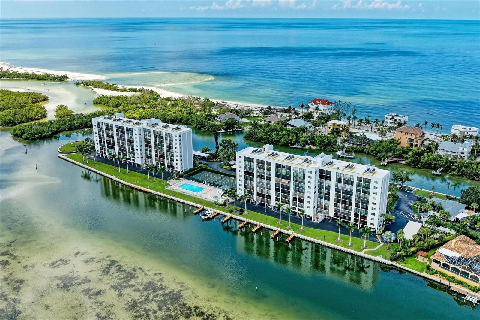 Here’s is your chance to live on the SOUTHER-MOST TIP OF SIESTA KEY and enjoy STUNNING SUNRISES & SUNSETS all year long. In fact, this is the CLOSEST CONDO to MIDNIGHT PASS and LOWEST PRICED 2-bedroom unit in the entire complex! This one-of-a-kind gated community encompasses over 5+ acres of PRIME WATERFRONT real estate and is loaded with amenities including tennis, pickleball, fitness center, heated lap pool, spa, dry sauna, kayak launch, clubhouse and more. Boat docks are also available for a small fee on a first come first serve basis. Rather go to the beach? No problem…Turtle Beach access is just about a half-mile away. And let’s not forget, just a few miles up the road are all the amazing restaurants and shops of Siesta Village. The first thing you’ll notice when you enter this turnkey-furnished, 2bed/2bath condo, is how the living area leads right out to an expansive 30-foot lanai overlooking Little Sarasota Bay and the Jim Neville Nature Preserve…a perfect spot for entertaining or just sitting back and enjoying the view and the wildlife. The primary bedroom also has access to the lanai and features an ensuite bathroom, finished closets, and of course, spectacular sunrise views. Engineered hardwood floors throughout give the home a cozy, beachy feel. Unlike other condos in the area, a washer/dryer is conveniently located within the unit. Recent updates include 5 new ceiling fans, new blinds, new range, newer dishwasher, and new furniture in the dining room and living room. AC was replaced in 2019. There is also additional storage space on the ground floor for all your beach and boating gear. Don’t miss out on your chance to own a piece of paradise! Schedule your showing today! Before you know it, you could be floating around the crystal blue waters of Midnight Pass and enjoying STUNNING SUNRISES & SUNSETS right from your own condo.