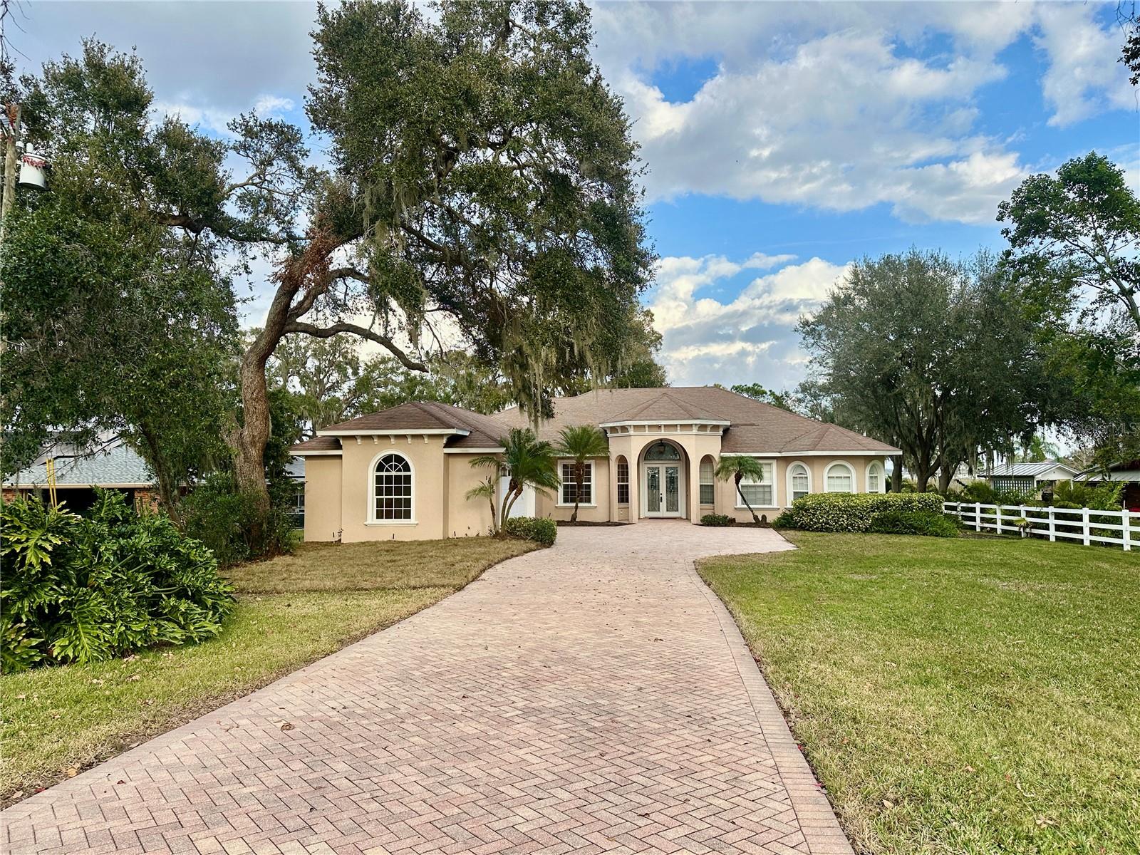 PRICE REDUCED! Stunning three-bedroom, two-and-a-half-bath home on .97 acres with breathtaking views of Lake Hamilton. This beautifully designed residence features an open floor plan, ideal for both entertaining and everyday living.
The split-bedroom layout offers privacy, with a luxurious master suite that includes French doors leading to the lanai, his-and-hers walk-in closets with custom built-ins, and a spa-like master bath complete with dual vanities, a jetted garden tub, and a separate shower.
On the opposite side of the home, bedrooms two and three share a Jack-and-Jill bathroom, each with a private vanity. An additional office with a closet provides a perfect space for remote work or a guest room.
French doors from both the family room and living room open to a covered, brick-paver lanai and a screened-in swimming pool with a stunning waterfall feature perfect for enjoying Florida's year-round sunshine. Wake up to picturesque sunrises over Lake Hamilton and experience lakefront living at its finest.
With no HOA restrictions, this property offers the freedom and privacy you desire. Schedule your private showing today!
