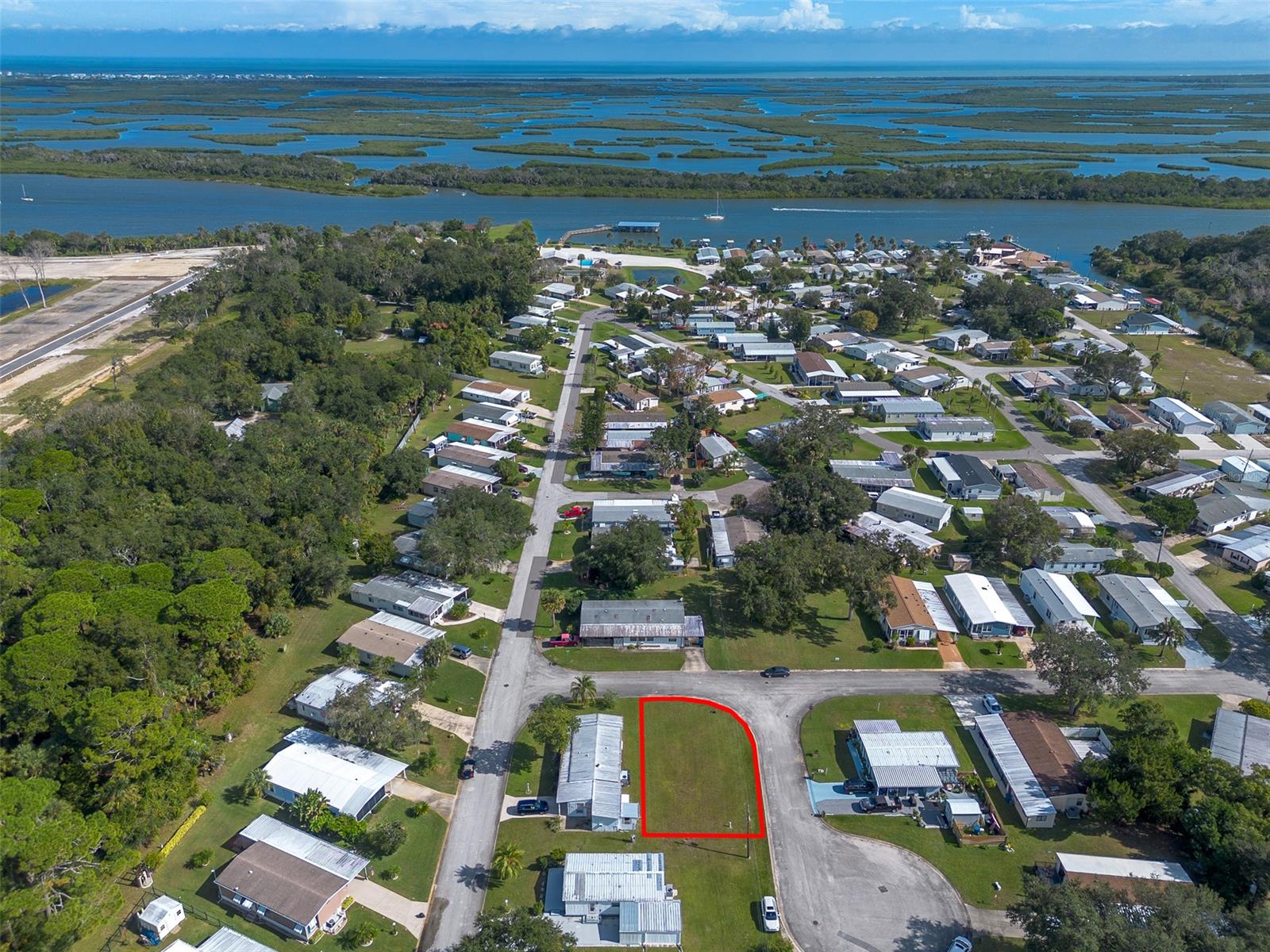 Discover a rare opportunity in Terra Mar Village, a serene fishing community nestled along the Intracoastal Waterway. Presenting a premier corner lot (185), this property stands as one of the last remaining gems in a quiet, low-traffic cul-de-sac. Unique in its M5 zoning, it offers the flexibility to build a new block, wood frame or constructed home, providing a alternative to traditional manufactured housing. The seller of this cleared, flat lot has been diligent in preparing to build and has obtained a survey and a county-approved variance for reduced setbacks, paving the way for a streamlined building process. Unlike typical community arrangements, owning this lot means no space rent, only a modest amenity fee contributing to the upkeep of luxurious facilities like two saltwater swimming pools, a newly constructed fishing pier with boat slips, a boat launch, and a clubhouse. Spanning approximately 50 x 100 feet, the lot sits outside a flood zone and has demonstrated resilience in recent storms, highlighting its suitability for coastal living. A preliminary site plan is available for a 1,000 sqft, 2-bedroom, 2-bath block home featuring two driveways and a carport. Imagine your life here, where rocket launches light up the sky, and days are filled with fishing, boating, and embracing the coastal lifestyle. Are you ready to build your dream and immerse yourself in everything this coastal community has to offer? All information intended to be accurate however not guaranteed.
