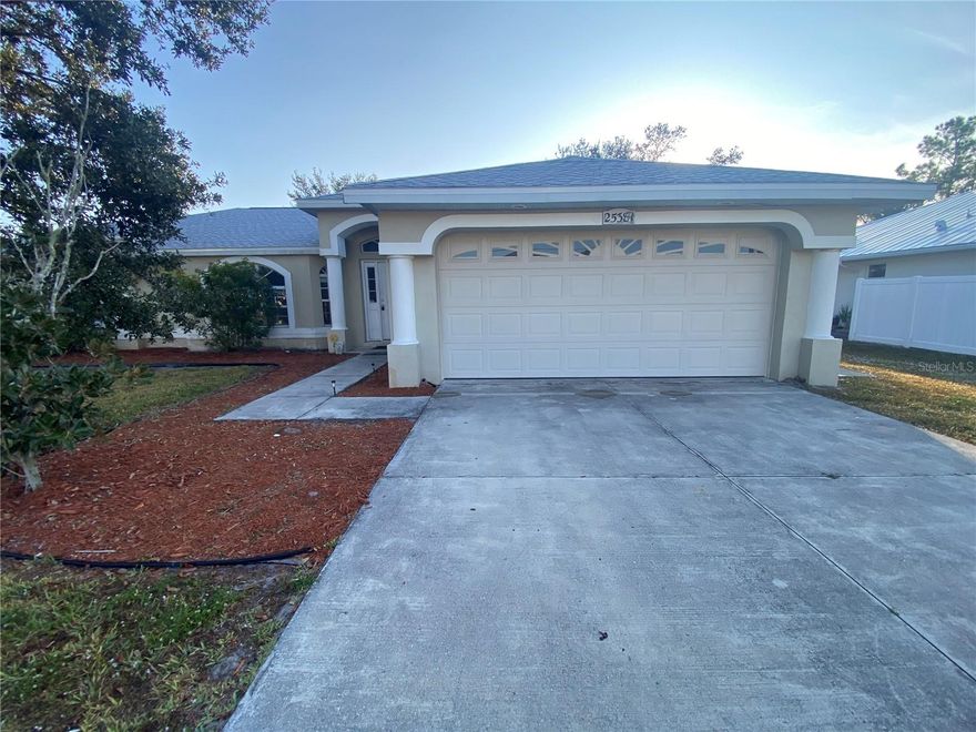 Welcome to this inviting single-family home offering comfort, space, and classic Florida charm. The attractive curb appeal features a wide driveway, two-car garage, and a covered entry with clean architectural lines and mature landscaping.

Inside, you’ll find an open floor plan with durable tile flooring in the main living areas, vaulted ceilings, and large windows that fill the home with natural light. The centrally located kitchen opens to the living and dining spaces and provides ample cabinetry, counter space, and a functional layout ideal for everyday living or entertaining.

The bedrooms are well-sized and thoughtfully arranged. The primary bedroom features soft carpeting, neutral tones, and plenty of natural light, creating a relaxing retreat. Additional bedrooms gives flexibility for guests, a home office, or extra living space.

Outside, enjoy a manageable yard perfect for relaxing or outdoor activities, along with an attached garage for parking and storage. Conveniently located near shopping, dining, schools, and major roadways, this well-maintained home offers both comfort and convenience.