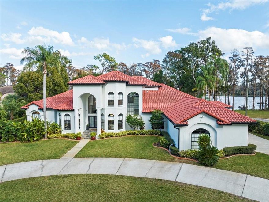 Discover unparalleled elegance and peaceful tranquility in this magnificent estate, located on Rock Lake in Odessa.   This 6-bedroom, 5.5-bathroom privately gated lakefront estate, is a perfect blend of opulence and functionality, this residence offers an array of exceptional features. Nestled on a quiet private road offers the feeling of being out in the countryside while still being near all the amenities with easy access to the city. Right out of the pages of a magazine, this true show home has been impeccably remodeled with designer finishes that reflect genuine pride in ownership! The moment you walk through the front doors into the foyer you will be blown away by the spacious open floor plan, Custom floor to ceiling wainscoting that sets the stage for the grandeur that awaits, natural light that draws your eyes to the glistening lake view and gorgeous luxury custom white oak hardwood flooring that grace the entire home. The remodeled kitchen is a chef's dream, boasting Cambria Britannica Quartz countertops, waterfall edges, two islands, and top-of-the-line GE Monogram Appliances. The custom wooden shelving and hood for the stove add to the culinary allure.
 
The first floor is home to a grand primary suite, featuring a fireplace and an impeccably remodeled bathroom. Revel in Quartz countertops, a freestanding tub, wall-mounted faucets, high-end fixtures, and a Moen Smart Shower with a frameless enclosure, multiple shower heads, and body jets. The adjacent music room, with a large closet, offers versatility as an additional bedroom or office, while the reading room shares a fireplace with the primary suite.
 
The first floor also encompasses an in-law suite with its own private bath and an additional bedroom. Entertainment options abound with a large bonus room, situated off the family room, ideal for a media center, office, or additional bedroom, provides another great vantage point of the pool and lake, with a pool bath for added convenience.
.
The laundry room has been transformed into a stunning space with custom wood shelving, a large central island, and even a custom dog wash bath, making laundry day a true pleasure. Upstairs, two additional bedrooms, a bath, and a loft area offer privacy and comfort.
 
Every living area including the primary suite, centers around the large glass doors leading to the Professionally designed outdoor Paradise with captivating lake views. The lakefront paradise is complemented by a private dock, 2 boathouses with a lift, and a rare private paved boat ramp for this skiable lake.
 
Step outside to the massive covered lanai, adorned with travertine, overlooking the heated pool, spa, and water features that enhance the outdoor activities. The outdoor kitchen nearby adds to the al fresco experience. The entire indoor/outdoor space is wired for zoned surround sound, featuring in-ceiling, mounted, and rock speakers.  The home also comes with a robotic mower that is programmed specifically for the property.
 
Too many updates and features to list all here so please see attached feature sheet.
 
This lakefront masterpiece redefines luxury living. Schedule your private tour today and immerse yourself in the unparalleled beauty of 7223 N Mobley Rd, Odessa. Bedroom Closet Type: Walk-in Closet (Primary Bedroom).