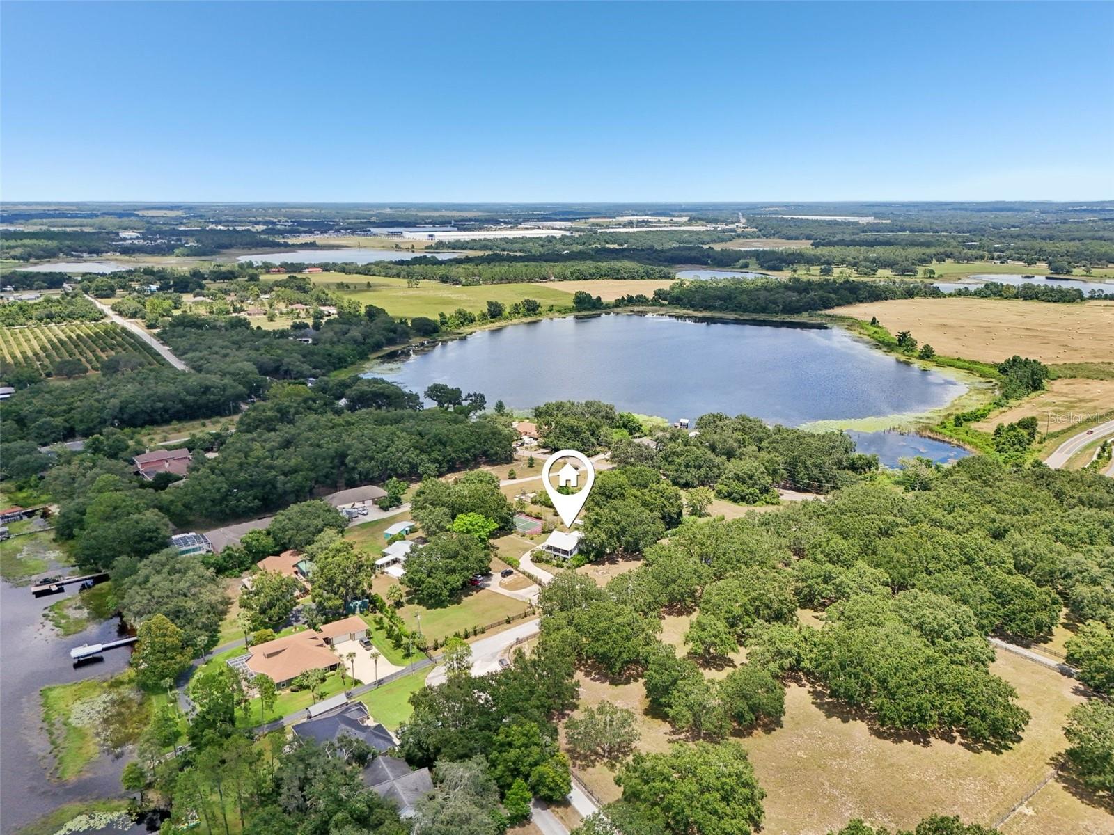 Beautiful GARDENS adorn 2.51 acres of this amazing homesite. It even feels like a real bird house among the majestic oaks with breathtaking views from the second story, above it all. This charming 2 story carriage-like house with 3 bedrooms and 2 bathrooms is so unique, you must own it! Dreamy views of Lake Emma at sunset from your balcony and LAKE ACCESS make it even more special. Another desirable feature is the rare opportunity to enjoy your own SPORTS / TENNIS COURT. Or perhaps convert the recently renovated court to pickle ball courts for even more fun and competition. No worries about the heat, you can light it up and play at night in lower temperatures. Other structures on this property include a creative play area in the trees, an Orchid greenhouse, extra storage in the pump house and a storage shed. Cross the bridge over fishpond to the secret garden under the trees used for many events and even weddings. Exterior gardens include multiple fruit trees: avocado's, oranges, grapefruit and lemon trees. There is a large gazebo for outdoor dining and a bon-fire area too. Star gazing is fabulous out here!
This lovely 2-story home overlooks lake Emma from the front balcony and the gardens plus sports court from the Florida sunroom. The primary and secondary bedrooms are located on the first floor with a private bathroom. This bathroom has a beautiful walk-in shower with small river stone tiles. Also, on the first level are: foyer, a den or study area and the laundry room. Working plantation shutters on the windows too.
Upstairs you enter the loft bedroom with French doors to the balcony and another private bathroom. Then, onto the Livingroom
with combination dining area and open kitchen. The kitchen is complete with stainless steel appliances. You'll love the double oven with convection cooking and over-the-range microwave with ventilation capabilities. Granite countertops form a functional breakfast bar too. Plenty of nice cabinets for kitchen wares and a large, walk-in pantry. This combo space also has French doors to the balcony with beautiful views.
Surrounded by windows, the Florida sunroom provides the ultimate views of the grand oaks, gardens and sports court. It's so relaxing, you'll want a day bed or change it into a private bedroom. Back down to ground level and under the Florida sunroom is a carport area.
Plenty of land to build your dream house or a big garage. No HOA restrictions here so, you can create all your dreams on this one-of-a-kind property. Home is priced to sell quickly. Book your appointment to tour now!
Easy TURNPIKE access within 2.5 miles. Only a few miles to historic downtown Clermont, Lakeridge Winery & Vineyards or charming Groveland. Groveland's Lake David Park offers all kinds of amenities including: a public boat ramp, dock, fishing, barbecue grills, basketball and volleyball courts, 2 picnic pavilions, picnic tables, large playground, and a skate park. Additionally, Groveland’s new splash pad is a fantastic spot to cool off. The park also hosts the popular Second Friday events, offering live music, food vendors, and a fun community atmosphere. Holidays are even more fun here! Come enjoy the lifestyle in Groveland "the city with natural charm."