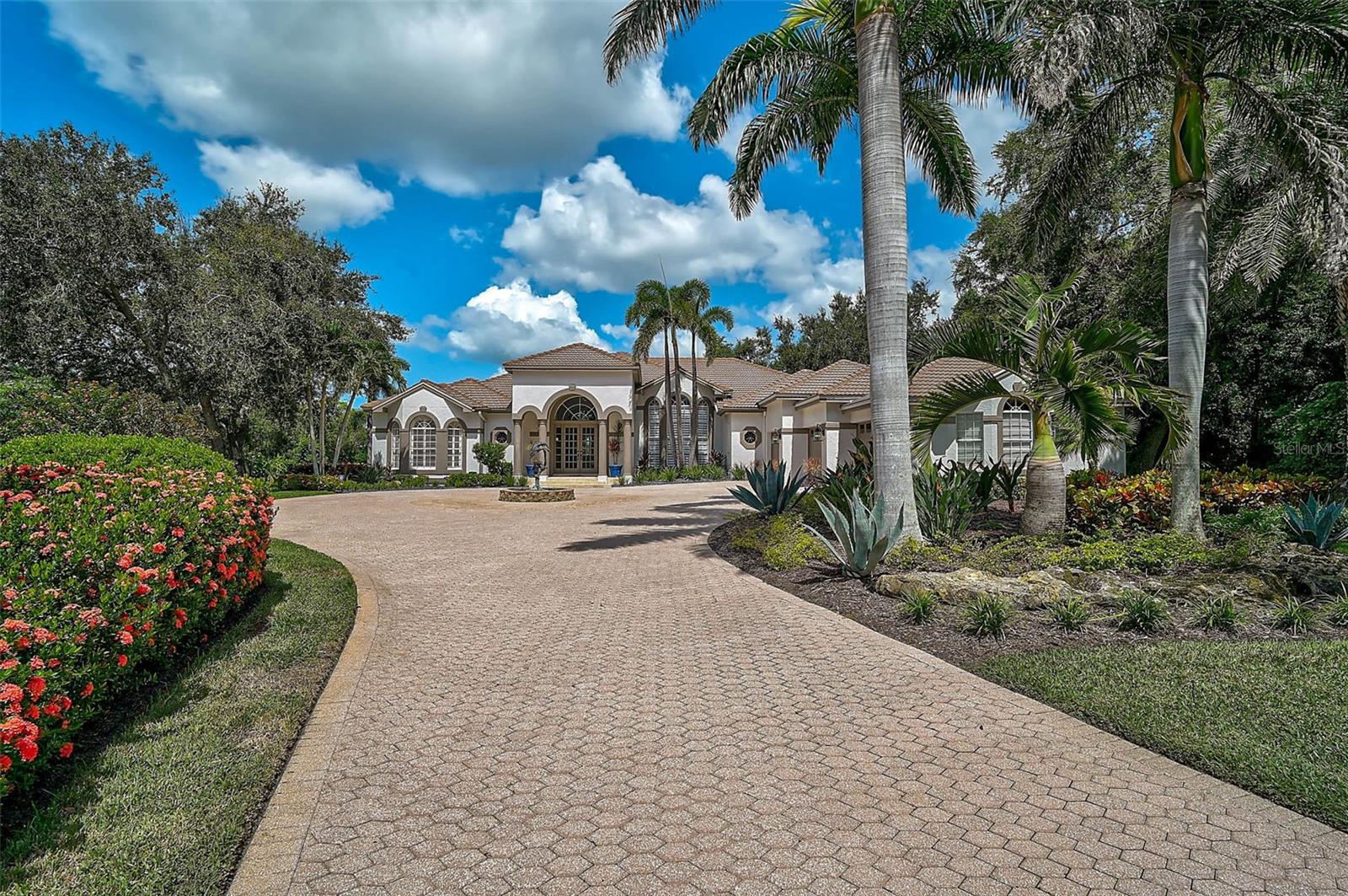 **BRILLIANTLY DESIGNED AND RENOVATED, CUSTOM GOLF COURSE ESTATE with SPECTACULAR WATER and GOLF COURSE VIEWS** is situated on the 8TH Green complex of the Interior HERON GOLF COURSE and is located on a tranquil, 0.59 Acre cul-de-sac lot behind the Secure Gates of The Oaks Country Club neighborhood. Featuring 4 Bedrooms PLUS Large Study/Den, 3 Full and 1 Half Baths, this Open Floorplan with Soaring Ceilings, Custom Built-Ins, Crown Moldings, Engineered Hardwood flooring and discerning architectural details throughout is ideal for entertaining both inside and out! The Impressive NEW Kitchen features Quartz Counters, Premium Stainless Steel appliances including Wolf and Subzero brands, and Large Island with seating area. The Expansive Primary Bedroom Suite entails a Bonus sitting area, multiple walk-in closets with custom built-ins and spacious bath with dual vanities, custom-tiled shower and large soaking tub. Oversized Guest Bedrooms in a private guest corridor are ideal for hosting your family and friends. Incredible Outdoor Entertaining area features a large, covered seating area and Heated Pool in an Expansive, Screened Lanai with an Ideal Southwestern Exposure. NEWer ROOF (2019), Hurricane Impact Windows & Doors (2020-2021), NEW Laundry Room and Much More! THE OAKS is a distinguished, 24hr Guarded, Country Club Community which boasts many accolades including: Platinum Club of America, Emerald Club of the World, Elite Distinguished Club of the World and One of America’s Healthiest Clubs - where amenities include Three Restaurants, Ballroom, Two 18-hole championship GOLF courses, award-winning RACQUETS program with 12 Har-Tru Hydro-Grid TENNIS courts, 4 PICKLEBALL Courts, wonderful CROQUET facility, state-of-the-art FITNESS center and junior Olympic, heated community SWIMMING POOL, Bocce, Basketball Court, Playground and more! The Oaks is just minutes from nationally ranked Pine View School, the Legacy Bike Trail, area Beaches and all that Gulf Coast living has to offer. Membership is required and there is NO WAITLIST for GOLF or SOCIAL Membership. **PLEASE ENJOY VIEWING THE 3D VIRTUAL TOUR and AERIAL VIDEO**