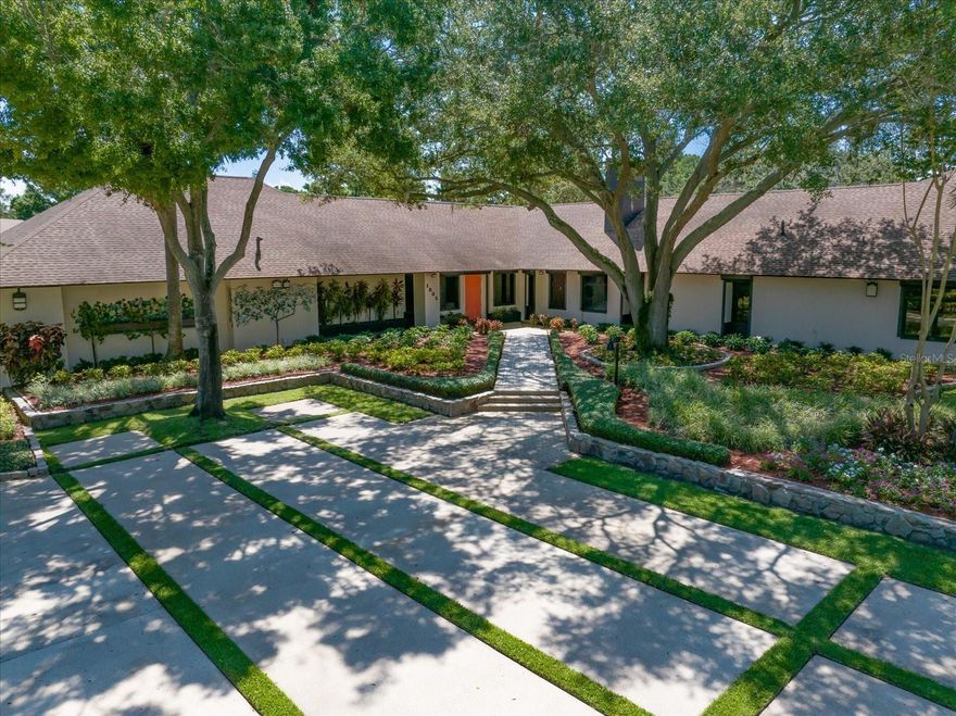 Prepare to be amazed by this extraordinary estate home tucked within Kent Place—one of Clearwater’s most coveted and private neighborhoods, where country-style living meets city convenience. Designed with vision and created with care, this home is a true masterpiece, ideal for car collectors, art lovers, or multigenerational living. Pride of ownership is evident from the moment you arrive, with impeccable landscaping, majestic oaks, and a stately executive presence. Step inside to a gallery-style foyer that sets the tone for the home's artistry and attention to detail. Just beyond, the Key West-inspired room transports you to the southernmost point of Florida with hand-painted murals, skylights, and a wall of floor-to-ceiling windows—a serene escape unlike any other. Entertain in style with a full wet bar leading to a cozy family room with fireplace and cigar cabinet and wine cellar, open to a chef’s kitchen featuring top-of-the-line stainless steel appliances, a center island with vent hood, and access to one of the home's showstoppers: an enclosed indoor pool and spa surrounded by custom murals of Tampa Bay's iconic landmarks. A commercial Wolf grill ensures unforgettable gatherings. The pool can be closed off and separated by glass, accordion sliders. The formal living and dining rooms are a work of art themselves, featuring custom wall murals and grand spaces perfect for hosting intimate dinners or entertaining on a grand scale. The primary suite is a world of its own, complete with a private office featuring a poured concrete safe, a second laundry, a sitting room with custom built-ins, a spa-like ensuite with jetted tub, walk-in shower, double vanities, and an unforgettable custom closet with lighted glass cabinetry, endless storage, and a substantial staircase leading to a cedar-lined closet. Guests will marvel at the castle-like guest suite with soaring ceilings, a whirlpool tub, walk-in shower, steam room, and sauna. Two additional bedrooms with walk-in closets and natural light share a Jack-and-Jill bath. An attached two-bedroom, two-bath apartment with full kitchen and theater room offers the perfect solution for a nanny, in-laws, or long-term guests. For the car enthusiast, a 6 bay garage with four car lifts allows for storing 10-cars. A dream come true, while a separate 3-car garage provides additional storage and access to a large laundry room. Hurricane impact windows with shutters, two home generators that will power a significant portion of the home, storage galore, and custom features around every corner make this a once-in-a-lifetime opportunity to own a truly remarkable Clearwater estate. Ideally located close to shopping, dining, two airports and pristine beaches .Don't miss your chance—homes like this are rare and unforgettable!