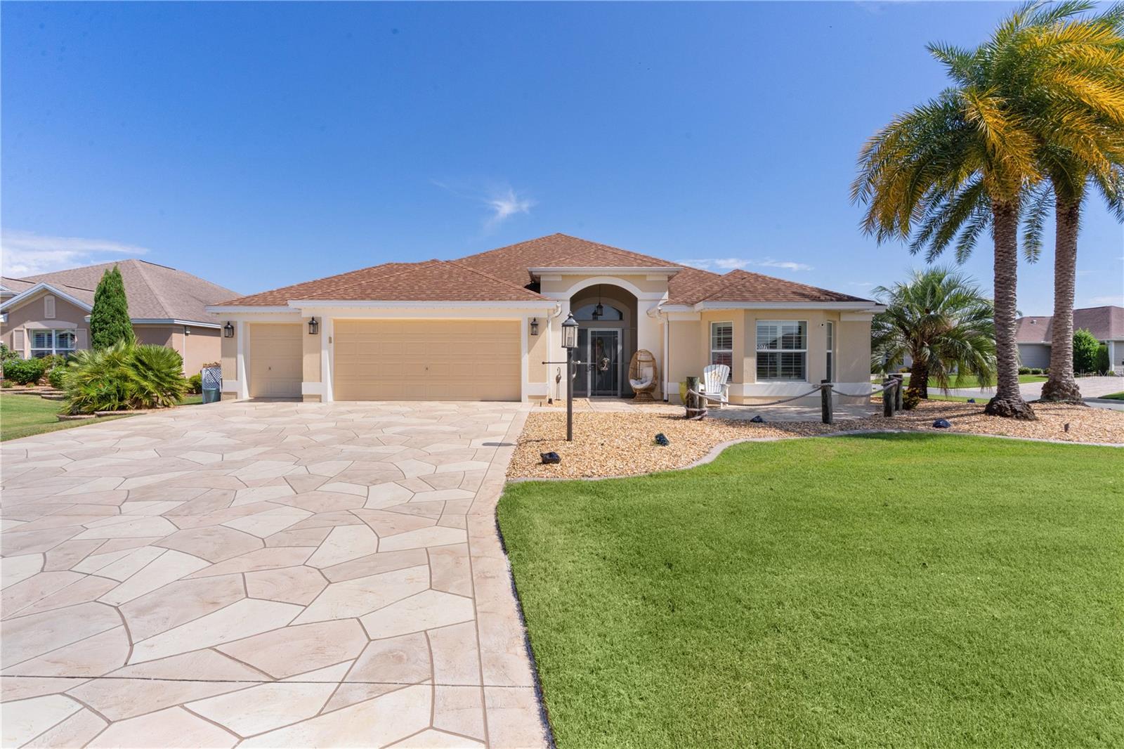 ~NEW LOWER PRICE~ ~CUSTOMIZED EXPANDED 3/2 LANTANA~ ~LAP POOL~ ~EXPANDED LANAI~ ~GOLF CAR GARAGE~ ~TILE FLOOR THRUOUT~ ~BRAND NEW HOT WATER HEATER~Private setting on cul-de-sac in the Village of PINELLAS. Curb appeal shines with brick paver patio and painted stamped concrete driveway. Step inside to soaring ceilings, CROWN MOLDING, and custom lighting, including a designer chandelier in foyer, and elegant PORCELAIN TILE throughout most of the home. The living and dining areas feature canned lighting, with ceiling fan in the living room, and elevated ceilings in the dining room, creating a bright and open feel. Kitchen is a thoughtfully fitted with LG cooktop and 2024 GE wall oven plus brand new microwave. Also out of the ordinary, the refrigerator is housed with custom panels to match upgraded cabinetry and the dishwasher is a 2024 BOSCH. Tasteful granite countertops & backsplash provide pizzazz. The primary retreat with vaulted ceiling and PLANTATION SHUTTERS, is completed by a luxurious ensuite featuring walk-in closet, QUARTZ counters, Roman-style tiled shower, and private water closet. Two spacious guest rooms include PLANTATION SHUTTERS, and stylish ceilings—one guest room is equipped with a MURPHY BED and tray ceiling. The guest bath impresses with a walk-in shower, QUARTZ vanity, and high ceilings. Additional features include a 2024 WASHER/DRYER, laundry room with cabinetry and built-in desk. This beautifully upgraded home boasts a 41-ft LAP POOL with waterfall and jets, custom finishes, and an expanded glass-enclosed lanai adding 900 sq ft of climate-controlled living space with ceramic tile, custom telescoping sliding doors, motorized blinds, and 2 mini-splits. A spacious 2-car plus golf cart garage features motorized retractable screens, painted floors, attic stairs, and a laundry tub. This rare find combines elegance, function, and outdoor luxury! ROOF, HWH, upgraded HVAC all 2013. Close to all shopping, restaurants at CR 466A & Powell. Minutes from Evans Prairie Country Club, Eisenhower Regional Rec Center, and several executive golf courses. Just a short golf cart ride to Brownwood Town Square. ROOF, HVAC, HWH all 2013.