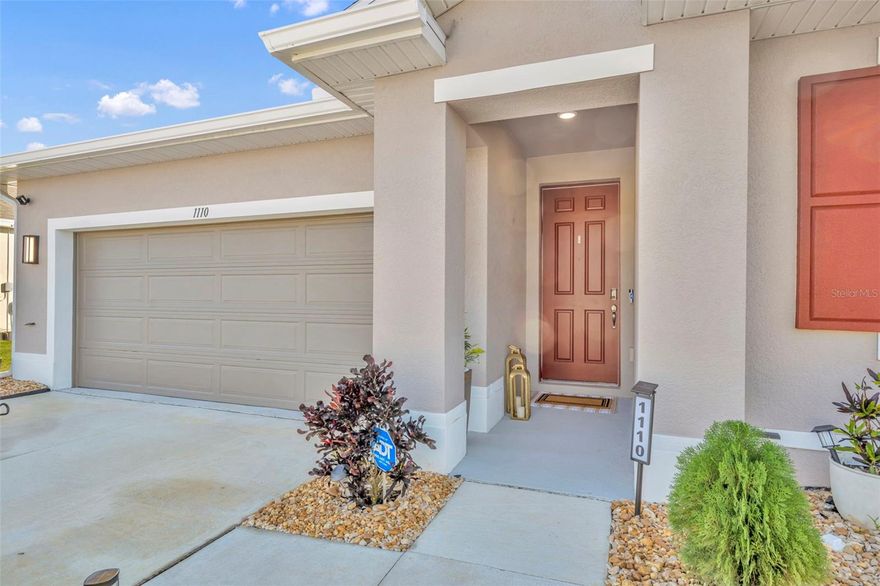 NEW PRICE...!  NO WAITING, FULLY UPDATED, BUILD LESS THAN A YEAR AGO! LOW HOA INCLUDES CABLE AND HIGH-SPEED INTERNET!   Feel immediately at home in this beautifully finished 2025 RUBY FLOOR PLAN by Richmond American Homes—a residence that blends new-construction freshness with the warmth and detail buyers often wait years to create.  This 4-bedroom, 2-bath home with 1,910 square feet has been carefully enhanced by the current owner beyond the builder basics, offering a level of finish and comfort that’s ready from day one. The heart of the home is the OPEN KITCHEN, where 42-inch cabinetry, a CUSTOM tile backsplash, and an EXTENDED island create a space that’s as practical as it is inviting. Ceramic tile flows throughout the main living areas, while thoughtful touches like custom pantry shelving and chrome PULL-OUT SHELVING in lower cabinets make everyday living effortless.  The upgrades continue outside. A new concrete slab supports a never-used HOT TUB that CONVEYS with the home, offering a private place to unwind without the wait or added expense. The SCREENED oversized lanai and fully FENCED YARD extend your living space outdoors, perfect for quiet mornings or relaxed evenings.  Inside, comfort and efficiency take center stage with a whole-home WATER SYSTEM, additional filtration at the kitchen sink and showers, ceiling fans in every room, and custom shelving in the primary walk-in closet. RAIN GUTTERS and other practical improvements round out a home where every addition was chosen with intention.With over $20,000 in UPGRADES already complete, this home offers something rare, the opportunity to move into a new build that already feels finished.  LOW HOA includes high speed WIFI and CABLE!  No waiting, no added projects, and no surprise expenses, just a home that’s ready to be lived in and enjoyed from the moment you arrive.  Did I mention the home comes with a brand new-never used hot tub!!!