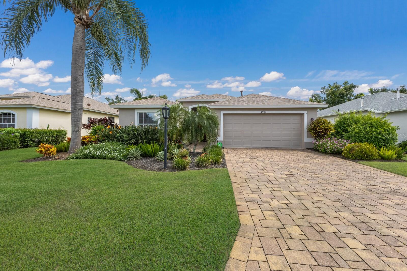 This meticulously maintained two-bedroom plus den, two-bathroom home in the sought-after Carlyle community of Palm Aire combines thoughtful design and updates and one of the most beautiful preserve views in the neighborhood.
Recent upgrades add both value and peace of mind, including a NEW ROOF (2023) and a complete exterior repaint with gutters and downspouts. In 2024, a new refrigerator, dishwasher, and stylish dining room light fixture were installed. Early 2025 brought even more improvements with a fully re-screened and repainted lanai cage, a new screen door, and refreshed landscaping behind the master suite featuring a Christmas Palm and vibrant shrubs.
Inside, the home welcomes you with an elegant glass entry door, soaring ceilings, ceramic tile floors, and an open layout designed for both comfort and style. The formal dining area flows effortlessly into the spacious great room, highlighted by double tray ceilings and crown molding.
The open concept kitchen offers soft-close wood cabinetry, granite countertops, and premium stainless steel appliances—including a gas range—along with a convenient breakfast bar. From here, sliding glass doors open to the lanai, where you’ll enjoy peaceful preserve views and the perfect setting for relaxing or entertaining.
Privately situated at the back of the home, the master suite offers tranquil views, a walk-in closet, and a spa-like bathroom with dual vanities and a walk-in shower.
Living in Carlyle also provides the option to join the Palm Aire Country Club, featuring two championship golf courses, a clubhouse, eight lighted Har-Tru tennis courts, an Olympic-size swimming pool, a state-of-the-art fitness center, and a playground. With no CDD fees, low HOA dues, and a premier location near University Parkway/UTC Mall, dining, shopping, airports, I-75, Lakewood Ranch, Benderson Park, Sarasota, St. Armands Circle, and world-renowned Gulf Coast beaches, this home truly offers the best of Florida living.