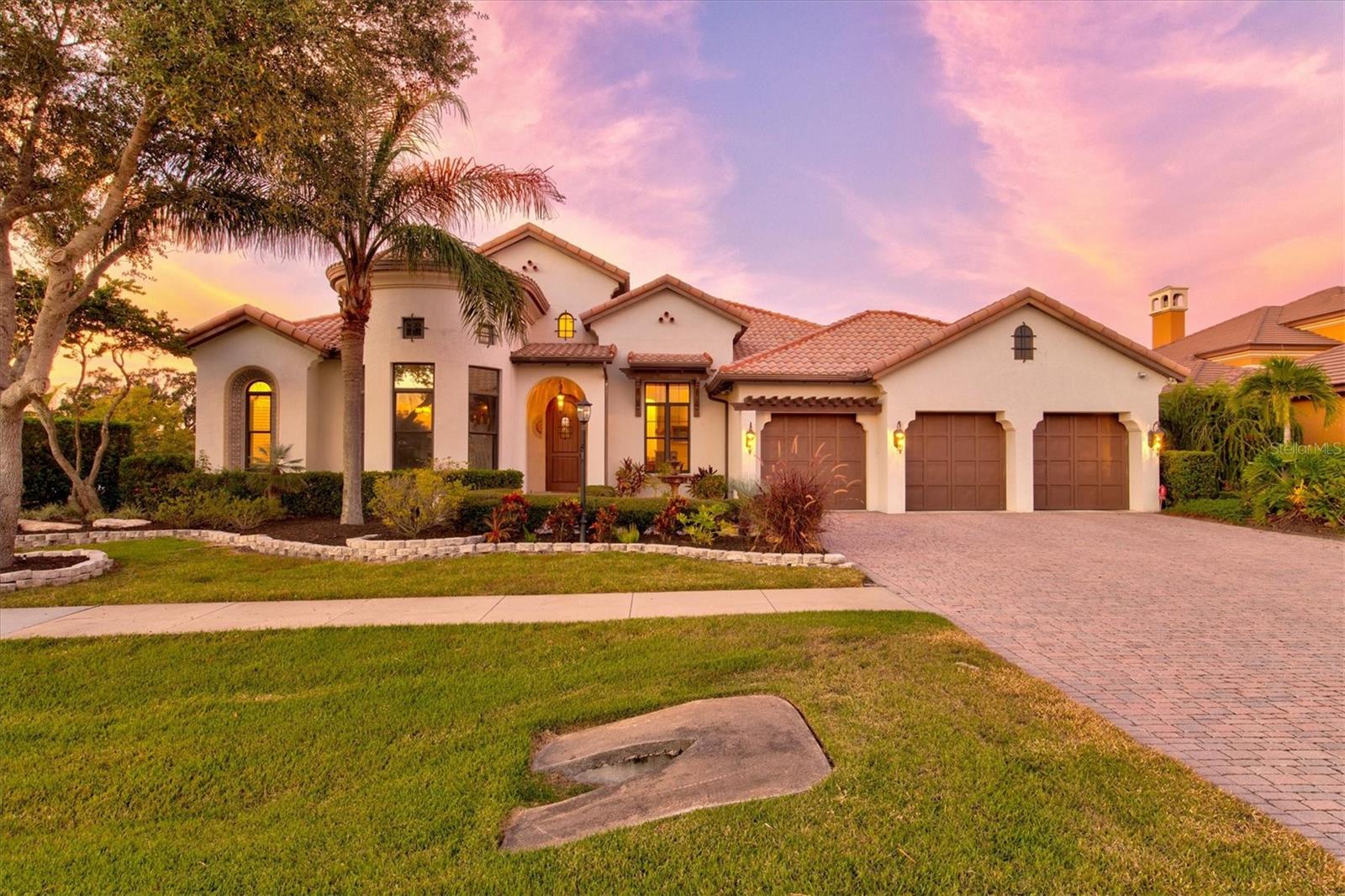 A RARE & UNIQUE OPPORTUNITY TO OWN A 2.63 ACRE ESTATE ON MANATEE RIVER! Discover your paradise with this stunning Arthur Rutenberg estate model home that sits on a double lot in the beautiful Winding River Community. Privacy abounds with lush tropical landscaping that borders the property from the view of neighbors. This expansive home offers over 5,000 sq ft of indoor living space that includes 5 bedrooms, 4.5 bathrooms, a large office, and upstairs theater room. You will be delighted as you enter through the beautiful arched front door and are greeted with soaring ceilings, wooden accent beams, and the rich, warm tones of the flooring. The kitchen is fit for the chef of the family and equipped with stainless steel appliances, a passthrough bar, three sinks and a walk-in pantry. The perfect home for hosting with double island seating that transitions seamlessly into the family and living areas of the home. Crown molding, tray ceilings and custom wood built-ins can be found in numerous rooms. The large owner’s suite will have you feeling like a king or queen with private lanai access, spacious walk-in-closets, dual vanities, a soaking tub, and walk-in shower. The split bedroom floor plan offers family members and guests alike both privacy and comfort. Invite everyone upstairs for a movie or game night and enjoy your favorite beverage or snack as you overlook the Manatee River from the upstairs balcony. From the main level the opportunity to transition to indoor and outdoor living comes with ease. With multiple covered seating areas, an outdoor fireplace, fully built-in kitchen, and beautiful paneled ceilings you won’t ever want to leave. The coveted Florida lifestyle is at your fingertips with an incredible pool and spa designed with beautiful cascading stone boulders that make you instantly feel like you’re at a resort. Just steps away is your very own tennis court, basketball hoop, playground, fire pit, dock, and 7,000 lb. boat lift. A true oasis with stunning curb appeal, beautiful landscape lighting, an upgraded/app-controlled irrigation system, and a variety of fruit trees that include lemon, lime, loquat, grapefruit, kumquat, mulberry, banana, and mango. Upgrades include but are not limited to: Whole house audio system with amplifier, room stations, and Bluetooth capabilities. Security system with InterLogix 2-way talking touchscreens, high speed ethernet cables, newer pool heat pump, speed pump, and spa pump all app controlled with Pentair. 2 of the 3 HVAC units were replaced in 2021 to a high efficiency Carrier 18 seer and 2021 Rheem hot water heater. Winding River is a maintenance free community with only 62 homesites offering a sense of country living yet still located minutes from I-75, restaurants, shopping centers, golf courses, beautiful parks, and the area’s top-rated schools. TONS OF POTENTIAL WITH THIS LOT HAVING THE ABILITY TO BE SPLIT AND SOLD FOR ADDED INCOME OR TO BUILD A NEW CUSTOM WATERFRONT HOME. Call for more details or to schedule a private showing!