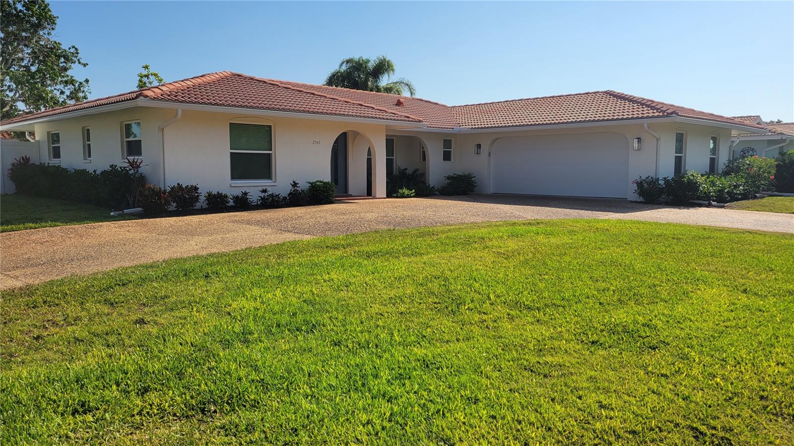 Seasonal or short term rental only Amazing beautifully renovated 3/2 home in a peaceful setting that is close to everything Sarasota has to offer. This home appears to be brand new construction of high end materials with stylish and comfortable furnishings in an open planned design. The property is flooded with natural light from new impact windows and doors. The flooring is all solid surface so NO CARPETING! The kitchen is spacious with solid wooden cabinetry, topped with slab quartz counters with breakfast bar, and complimented with stainless steel appliances. The main bedroom is roomy, sunny with multiple windows, and has a king sized bed, walk in closet, and ensuite bathroom with dual sinks walk in glassed in shower. There is a fenced in back yard with a patio set up for al fresco dining, and a very private outdoor shower. The owner keeps a car in the garage but there is enough space for an additional vehicle. As you step outside this home to look around you see trees and water across the street yet you are close to shopping, casual and fine dining, downtown Sarasota, the theater, opera, museums, and only 6 minutes to Siesta Key! This home can be rented for 3 month minimum during high season (December thru April) at $4500/month + tax or off season (rest of the year) for $3250 month + tax. You deserve a break in paradise-call today!