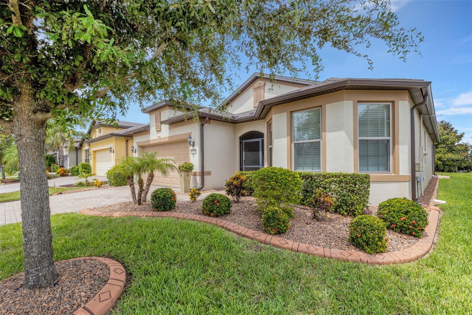 Located in the desired 55+ RESORT-STYLE community of Del Webb Orlando, this Beautiful Summerwood floor plan is a MUST SEE! This home features 2 bedrooms + a den, and 2 bathrooms. You walk into the screened front porch and through the decorative front door into the open floor plan. The guest bedroom with bay window and bathroom are in the front of the home. The heart of the home, the kitchen, features stainless steel appliances including a NATURAL GAS STOVE, lower cabinet pull-outs, granite countertops, a backsplash, a large island perfect for entertaining, and a spacious pantry. The PRIMARY BEDROOM is in the rear of the home for owner privacy and features a tray ceiling. The primary bathroom suite features double sinks with granite countertops, a large walk-in tiled shower, and a large walk-in closet. The dining room is conveniently located adjacent to the kitchen. The large living room features large glass sliding doors that open to the covered lanai with an additional screened cage and NATURAL GAS HOOK-UP. The large laundry room includes a utility sink and built-in cabinets. The 2-car garage includes a tandem space for golf cart parking or extra storage. The garage includes built-in storage cabinets. The additional home features include updated lighting and ceiling fans, newer carpet in the bedrooms, and a NATURAL GAS hot water heater. The exterior of the home features a paver driveway, gutters and concrete landscaping curbing. The $277 monthly Del Webb HOA fee includes exclusive access to resident-owned 30,000+ SF Montecito clubhouse and amenities. DEL WEBB ORLANDO is a 55+ community with a tavern, indoor walking track, fitness center, indoor and outdoor pools and spas with locker rooms and showers, billiards, ping pong, craft room, and a ballroom for special events. Outdoor activities include pickleball, tennis, bocce, basketball, shuffleboard, community gardening center, an outdoor amphitheater, large brick fire pit and large screened-in gazebo over the water. Miles of biking and walking trails within Ridgewood Lakes gated community. The $425 semi-annual HOA fee provides 24x7 staffed security gate and master association-owned private road maintenance. Adjacent to recently renovated 18-hole White Heron Golf Club. Community is located conveniently to shopping at Posner Park (4 miles), Disney World, Universal Studios, Orlando & Central FL.