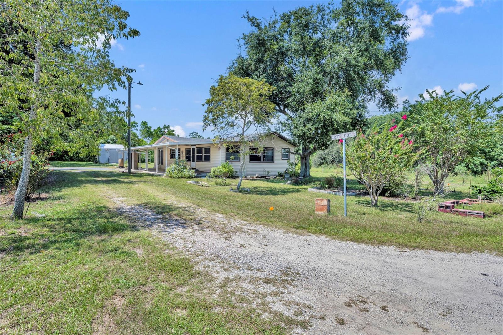 Charming 2-bedroom, 1-bath home with a versatile 12' x 12' den/office/bonus room which could also be used as a bedroom, offering 1,280 sq ft of comfortable living space at the end of a quiet and secluded dead-end street—just minutes from downtown Eustis and Mount Dora. Inside, you’ll find a spacious 12' x 8' laundry room for added convenience and a pull-down ladder attic access. The home also features a 22' x 8' enclosed covered tiled porch, perfect for relaxing or entertaining, along with a 40' x 14' covered patio/carport for plenty of outdoor use and plenty of room to park your boat and RV. Two storage sheds (16' x 12' and 10' x 12') provide ample space for tools, hobbies, or extra storage. Major updates include a 2011 septic tank, 2021 drain field, and 2016 roof, giving peace of mind for years to come. A rare find with extra land, storage, and proximity to historic downtown charm—this one won’t last long!