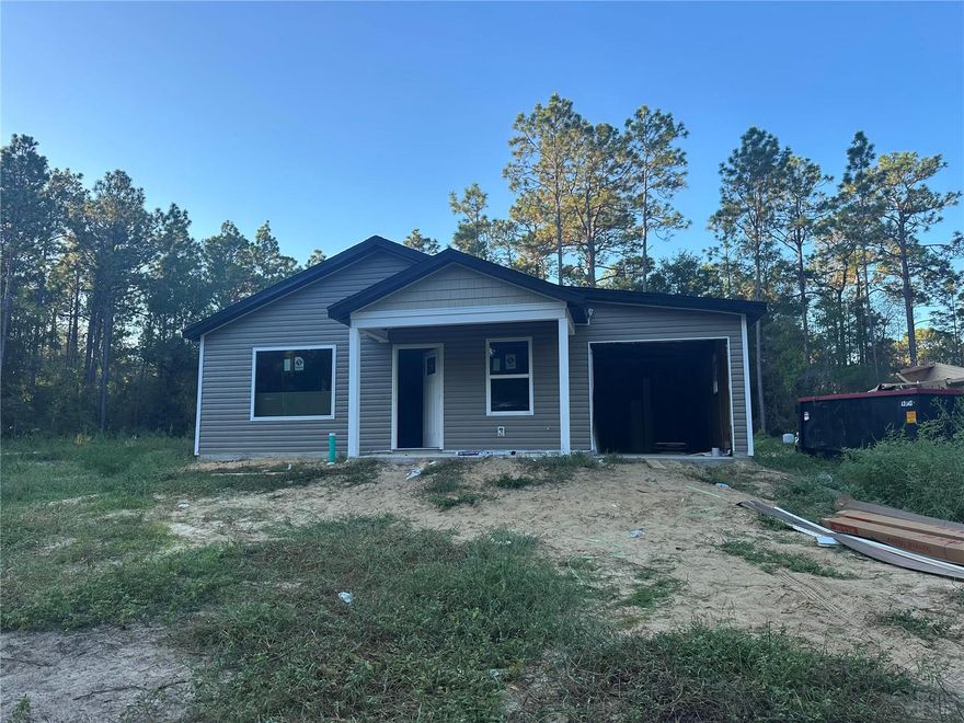 Now offering $5,000 in concessions and Down Payment Assistance with approval. Welcome to this exciting new construction project, a charming and affordable cottage home in the desirable Rainbow Park neighborhood, just a quick drive to the scenic Rainbow River. This home offers an excellent opportunity to experience comfortable living with its well-designed features. Key Features: Spacious Rooms: Enjoy the luxury of generously sized rooms, providing plenty of space for relaxation and everyday activities. Open Kitchen: The home features an open kitchen layout, creating a seamless flow between the kitchen and living areas, perfect for entertaining and family gatherings. Elegant Kitchen Upgrades: The kitchen will showcase granite countertops, adding a touch of elegance to your culinary space. Stainless steel appliances provide modern convenience and functionality. Stylish Flooring: The choice of vinyl plank flooring enhances the home's aesthetic appeal while offering easy maintenance and durability. Country Porch: Picture yourself unwinding on the charming country porch located at the front of the home. It's an ideal spot to enjoy the neighborhood atmosphere and relax outdoors. Unique Roof Design: This home stands out with its 6' 12" pitch roof, adding character and curb appeal, making it one of the most adorable houses in the neighborhood. Three Bedrooms, Two Bathrooms: With three bedrooms and two bathrooms, this home offers a comfortable living space, providing ample room for residents and guests. 1-Car Garage: The inclusion of a 1-car garage provides convenient parking for your vehicle and additional storage space. Cleared Land: The property's land is already cleared, laying the foundation for a smooth and timely construction process. Please note that the home is currently under construction. While pictures and virtual tours are available to offer an accurate depiction of the completed home, there might be slight variations in interior colors. Given its appealing features and prime location near Rainbow River, this home is expected to sell quickly. Don't miss out on the opportunity to own a lovely cottage home in Rainbow Park—an alternative to tiny home living without compromising on the number of bedrooms. Color will be Linen "MEDIUM BROWN" on this home