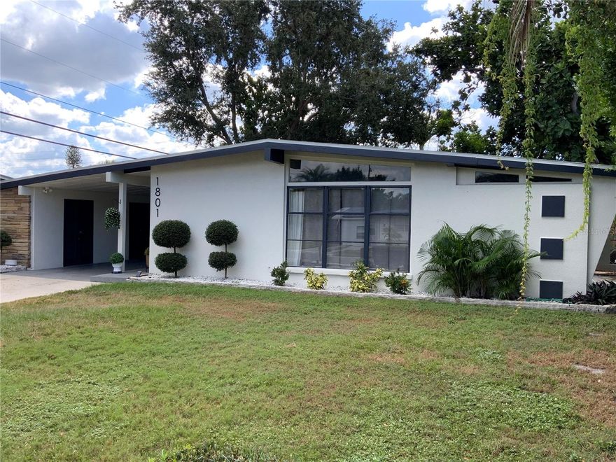 Major Price Adjustment!!! This home is an exceptional Mid-Century Modern Marvel built when homes were custom crafted with quality construction and appealing architecture, providing ambiance unlike the current Florida cookie cutter-style homes.   If you are seeking a “wow” factor and uniqueness in style and décor, this is the home for you!  Upon entering the home, you will immediately notice the light and bright open floor plan that includes a dining room with built-in hutch, an airy kitchen and large living room.   The kitchen boasts white quartz countertops, shaker cabinets and island, making food preparation enjoyable.  Pull out drawers were installed in the cabinets, and a pull-out trash receptacle cabinet was added. The pantry also has pull out drawers. Stainless steel appliances enhance the kitchen’s appeal. The breakfast bar is the perfect gathering spot to interact with the chef.  The separate den/office/bonus room is off the living area and has direct access to the back yard.  Storage and laundry are under the carport. This home features four bedrooms.  The primary bedroom is located at the rear of the home, while Bedroom 2 across the hall is being used as a large walk-in closet for the primary suite.  The third smaller bedroom serves as a guest bedroom and toy room/storage.  The fourth bedroom, separate from the other bedrooms, is the largest, with its own mini-split a/c system, and set up as a teen suite with private entry. The Seller has spared no expense in remodeling their home.  With a new a/c system, newer roof, refrigerator, stove (2025), luxury vinyl flooring, interior painting, aesthetically appealing new 1/4”, low iron glass installed in the original frames of the front window, remodel of the 4th bedroom, and updated primary bathroom, this house is truly “move-in ready”.    There is also a new 12'x10' shed in the backyard. Enjoy your private, fenced, backyard with a fire pit for BBQs, entertainment, reading or friendly get-togethers.  Added parking for boat/RV is available.  Bayshore Gardens Park/Recreation Center is located on Sarasota Bay, offering residents access to the marina and private boat ramp.  Boat slips are available, on a first-come, first-served basis at discounted rates.  Additional amenities include boat and trailer storage, recreation hall, community junior Olympic-size swimming pool, ball fields, playground, grilling area, picnic pavilions, pickleball and basketball courts and kayak/canoe racks.  A fishing pier and viewing area of Sarasota Bay add to the attractions of this waterfront community. Bayshore Gardens is conveniently located between downtown Bradenton and Sarasota, minutes from Sarasota-Bradenton International Airport, nearby IMG Sports Academy, the UTC Mall, Saint Armands Circle, Longboat Key and Anna Maria Island’s white sandy beaches.  Also nearby are local shopping, eateries and entertainment for all. Do not miss the opportunity to own this stunning Mid-Century Modern home.  Schedule your private showing today!