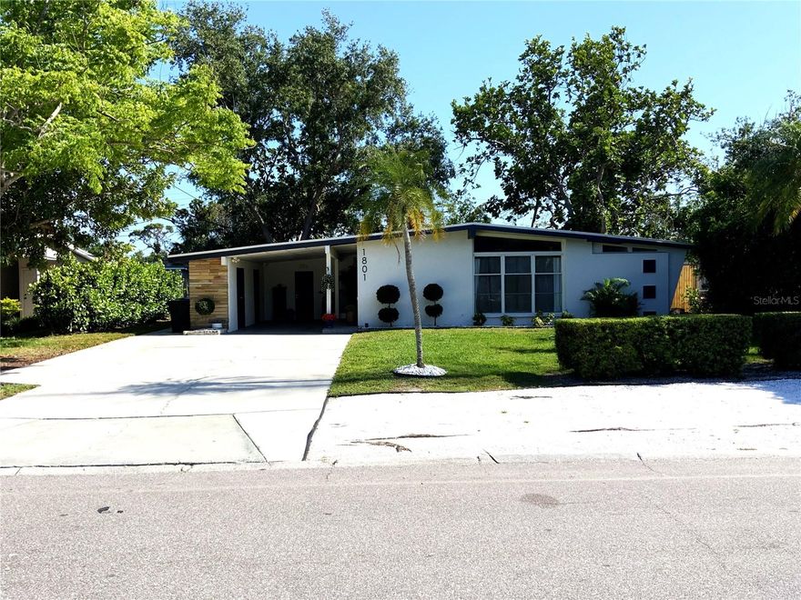 Major Price Adjustment!!! This home is an exceptional Mid-Century Modern Marvel built when homes were custom crafted with quality construction and appealing architecture, providing ambiance unlike the current Florida cookie cutter-style homes.   If you are seeking a “wow” factor and uniqueness in style and décor, this is the home for you!  Upon entering the home, you will immediately notice the light and bright open floor plan that includes a dining room with built-in hutch, an airy kitchen and large living room.   The kitchen boasts white quartz countertops, shaker cabinets and island, making food preparation enjoyable.  Pull out drawers were installed in the cabinets, and a pull-out trash receptacle cabinet was added. The pantry also has pull out drawers. Stainless steel appliances enhance the kitchen’s appeal. The breakfast bar is the perfect gathering spot to interact with the chef.  The separate den/office/bonus room is off the living area and has direct access to the back yard.  Storage and laundry are under the carport. This home features four bedrooms.  The primary bedroom is located at the rear of the home, while Bedroom 2 across the hall is being used as a large walk-in closet for the primary suite.  The third smaller bedroom serves as a guest bedroom and toy room/storage.  The Bonus room, or fourth bedroom, is separate from the other bedrooms, with access under the carport, is the largest, with its own mini-split a/c system and set up as a teen suite. The Seller has spared no expense in remodeling their home.  With a new a/c system, newer roof, refrigerator, stove (2025), luxury vinyl flooring, interior painting, aesthetically appealing new 1/4”, low iron glass installed in the original frames of the front window, remodel of the 4th bedroom, and updated primary bathroom, this house is truly “move-in ready”.    There is also a new 12'x10' shed in the backyard. Enjoy your private, fenced, backyard with a fire pit for BBQs, entertainment, reading or friendly get-togethers.  Added parking for boat/RV is available.  Bayshore Gardens Park/Recreation Center is located on Sarasota Bay, offering residents access to the marina and private boat ramp.  Boat slips are available, on a first-come, first-served basis at discounted rates.  Additional amenities include boat and trailer storage, recreation hall, community junior Olympic-size swimming pool, ball fields, playground, grilling area, picnic pavilions, pickleball and basketball courts and kayak/canoe racks.  A fishing pier and viewing area of Sarasota Bay add to the attractions of this waterfront community. Bayshore Gardens is conveniently located between downtown Bradenton and Sarasota, minutes from Sarasota-Bradenton International Airport, nearby IMG Sports Academy, the UTC Mall, Saint Armands Circle, Longboat Key and Anna Maria Island’s white sandy beaches.  Also nearby are local shopping, eateries and entertainment for all. Do not miss the opportunity to own this stunning Mid-Century Modern home. Possible temporary 1-0 buydown rate covered by lender. Call for details. Schedule your private showing today!