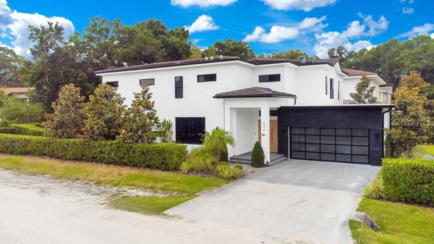 Take a look at this gorgeous contemporary home built in 2019 on a premium corner lot in the heart of Downtown Windermere. The home was built using the finest materials to compliment extraordinary lifestyles. It was constructed using impact windows and doors with block construction. Upon first glance you will immediately notice the striking curb appeal with modern accents and a large solid oak double door entry welcoming you home. The main level is adorned with large porcelain tiles, smooth textured walls, and an inviting open floor plan perfect for entertaining. The European inspired chef’s kitchen is fully equipped with Thermador stainless steel appliances, large hidden refrigerator, wine cooler, two sinks, natural gas cooktop with a center island, and walk in pantry. Nano doors invite you the enjoy the outdoor living space with a resort style heated pool & spa waterfall complimented with a covered lanai including a summer kitchen with a stainless-steel grill, hood, refrigerator, and sink for enjoying all those memorable barbecues. There is an en-suite guest bedroom conveniently located on the main level. The solid oak stairs with glass railing lead you to a spacious loft and balcony overlooking the backyard. Primary bedroom suite is grand with white oak floors, large windows, huge walk-in closet, dual vanities, garden tub, and a glass shower. The secondary en-suite bedrooms are all spacious with plenty of closet space. Home is also equipped with a Kohler natural gas generator and security cameras. Enjoy the cool lake breezes and the majestic landscapes of Downtown Windermere. The small town is golf cart friendly and has plenty of activities which include a weekly farmers market, monthly food truck event, boat access to The Butler Chain of Lakes & Lake Bessie, tennis courts, and plenty of parks. This exceptional home is move in ready and waiting for you. Be sure to click on the virtual tour link.
<iframe width='853' height='480' src= https://my.matterport.com/show/?m=Wda7KZtiNFc&mls=1></iframe>