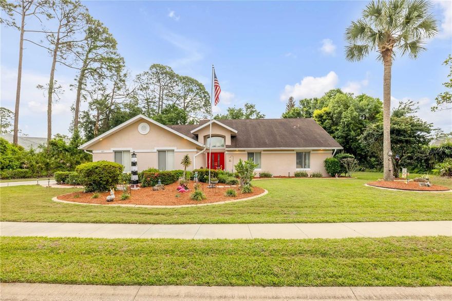 Welcome to this beautifully maintained single-family home in the desirable Muirfield at Indigo Lakes community. Offering 3 bedrooms, 2 bathrooms, and 2,447 square feet of living space, this property sits on just under half an acre, providing both space and privacy. From the moment you arrive, the expansive driveway and side-facing two-car garage create a strong first impression. Inside, vaulted ceilings enhance the open, airy layout, seamlessly connecting the living room, kitchen, and dining area. The kitchen is designed for both function and style, featuring solid wood cabinetry, abundant counter space, and a convenient breakfast bar. Just off the dining area, sliding glass doors lead to the backyard, making indoor-outdoor living effortless. A wood-burning fireplace anchors the main living space, adding warmth and character. The primary suite is spacious and inviting, complete with vaulted ceilings, a built-in closet, and a spa-like en suite bath with dual sinks, a soaking tub, and a separate walk-in shower. Additional bedrooms are generously sized and versatile. Step outside to your private retreat—a screened-in lanai with an in-ground pool, surrounded by mature landscaping and trees for added tranquility. Conveniently located just minutes from shopping, dining, major highways, and only a short drive to the area’s beautiful beaches, this home offers the perfect blend of comfort, space, and location. Mortgage savings may be available for buyers of this listing.