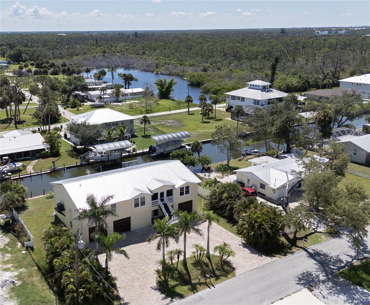 Direct access to the Gulf of America with no bridges and no limits!
Wake up to sparkling canal views, step onto your boat, and reach the Gulf of America within minutes. This stunning 2013 elevated coastal home offers the perfect combination of luxury, comfort, and the true Florida lifestyle.
Featuring 4 bedrooms and 3 bathrooms, this spacious retreat is crafted for both family and guests. The primary suite serves as a private sanctuary with a generous sitting area and a spa-like ensuite. On the opposite side, two bedrooms share a versatile Jack and Jill bonus room that works beautifully as a playroom, office, or media space. A private fourth bedroom delivers tranquil water views and makes an ideal guest space.
At the heart of the home, the chef’s kitchen impresses with custom wood cabinetry, stainless steel appliances, and expansive granite countertops that are both elegant and functional.
The ground level is built with solid concrete block, providing abundant parking and storage along with private elevator access for effortless convenience.
Step outside to your tropical oasis, complete with a heated saltwater pool and spa surrounded by lush greenery. The private dock is equipped with boat and jet-ski lifts and offers direct deep-water access to Lemon Bay and beyond. Within minutes you can be enjoying sandy beaches and open water adventures.
Best of all, this waterfront retreat is close to Englewood’s finest restaurants, fresh seafood on the water, upscale shopping, and charming boutiques, making every day feel like a vacation.
This is more than a home. It is a lifestyle, a sanctuary, and a dream waiting to be lived. Schedule your private showing today.