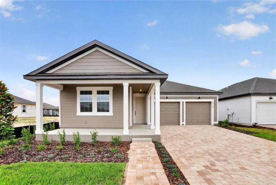 This thoughtfully designed home in the Trailside community features 4 bedrooms, 3 baths, and 2-car garage. The open floorplan offers abundant natural light and a seamless flow through the main living areas, which showcase beautiful wood-look luxury vinyl plank flooring. The kitchen is equipped with 42" cabinets, a large island with upgraded quartz countertops, and stainless steel appliances—perfect for everyday living and entertaining. Plush upgraded carpet adds comfort in the bedrooms, plus upgraded 8' interior doors are included throughout. The interior design selections feature the AW Collection Minimalist, bringing clean lines and modern style throughout. Bring the outdoors in with a covered lanai just off the living area. Enjoy community amenities including a pool, clubhouse, and playground. Conveniently located near top-rated schools and the charming shops and restaurants of downtown Mt. Dora.