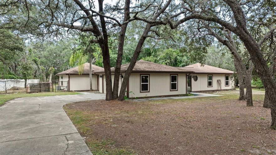 Welcome to your future home at 15005 Noon Court, Spring Hill, FL 34610 a spacious 3 bed 2 bath private retreat nestled in the tranquil Shady Hills area. This unique home sits on around 1.24 acres, offering generous yard space and privacy with beautiful pond in the views. Vaulted ceilings with exposed beams in the main living area and master create a rustic feel. Kitchen with modern finishes, stainless appliances, and ample cabinetry. Master suite with garden tub, dual vanities, and separate tiled shower. The spacious secondary bedrooms are across the house and have a shared bonus area that would be used as a play area, sitting room or office. There is a large laundry room with washer and dryer hookups, a detached 2 car garage and long driveway offering plenty of parking. Quiet, shaded neighborhood in Shady Hills, just off County Line Road, offering a peaceful, semi-rural feel while still accessible to major roads. Close to local shopping centers, dining, and services. Nature and recreation nearby: beaches, parks, and the famous Weeki Wachee Springs are all within easy reach.

$75 App fee/adult, security deposit equal to one month's rent, $300 Non Refundable Pet Fee Each Pet,  $75 tenant annual processing fee each household after acceptance, renter's insurance required.