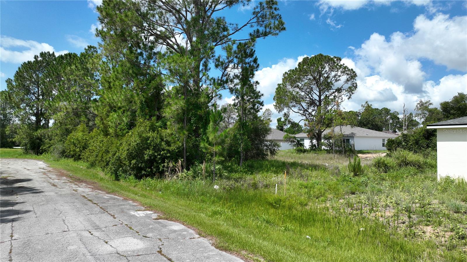 Embark on a journey to realize your dream home with this exceptional vacant lot for sale. Nestled within the Poinciana Villages, this lot offers the perfect canvas to craft a home that suits your vision and preferences. Indulge in the abundance of amenities that await you, as the Poinciana Activities Campus beckons with its diverse offerings. Dive into a world of leisure and recreation with access to a splendid pool, aquatics center, and a well-equipped fitness center. Nature enthusiasts will find solace in the numerous parks, playgrounds, and trails that invite you to explore the outdoors. For those seeking competitive excitement, the presence of a basketball court, racquetball courts, and tennis courts guarantees endless opportunities for friendly matches and spirited games. The clubhouse serves as a hub for community gatherings, where residents can come together and create lasting memories. Moreover, the allure of this location extends to its proximity to various attractions. The enchantment of Disney, the allure of outlet malls, and the wonders of SeaWorld are all within easy reach. Immerse yourself in the magic of Orlando's attractions, and embrace a lifestyle where entertainment and adventure are just moments away. This vacant lot presents an incredible opportunity to shape your own haven in a thriving community. Create the home you've always envisioned, with access to an array of amenities that cater to every aspect of your well-being. Don't miss the chance to call this place your own and savor the lifestyle you've always desired. Seize the moment and make your dream a reality. Schedule a viewing today and envision the endless possibilities that await you on this remarkable vacant lot, where you can build your perfect abode and embrace the vibrant spirit of Poinciana Villages.