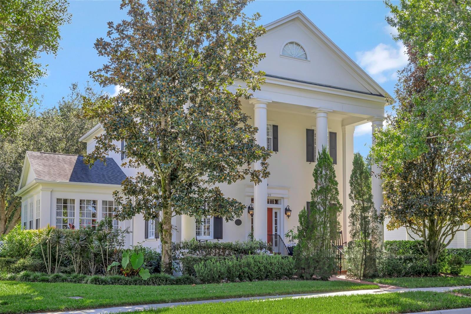 Welcome home to classic southern elegance in Celebration’s coveted Artisan Park. Discover timeless architecture and modern comfort in this impeccably maintained Issa Homes “Caldwell” model, set on a rare half-acre homesite that backs onto a protected Eagle Preserve greenbelt. Morning sun bathes the expansive, fully fenced backyard—ideal for a future pool, summer kitchen, or elegant garden retreat—while mature landscaping ensures privacy and a serene natural backdrop. Inside, every detail speaks of craftsmanship and care. Wide 5-inch plank hardwood floors, smooth high ceilings, crown molding, porcelain switch plates, and plantation shutters create a refined aesthetic throughout. The main level offers gracious living and entertaining spaces, including a sun-filled family room, a glass-wrapped sunroom, and a private office behind French doors. The gourmet kitchen features 42-inch cabinetry, granite counters, stainless-steel appliances, a breakfast bar, and a cheerful nook for casual dining. Upstairs, the owners’ suite is a sanctuary with two walk-in closets—including an oversized “hers” closet—and luxurious sculpted wool carpeting. Additional bedrooms, a well-appointed laundry room, and designer lighting complete the upper level. A three-car garage is complemented by a beautifully finished detached apartment with its own kitchen, living area, bedroom, bath, and laundry—perfect for guests or income potential. Since 2016, the residence has benefited from extensive enhancements and thoughtful upgrades: a new roof, four new A/C units, fresh interior and exterior paint, a tankless water heater for the guest house, new stainless appliances (including wall-oven combo and range hood), designer ceiling fans, updated faucets throughout, a new washer and dryer, and a 2025 vinyl privacy fence. Conceived by Disney as a model town where nature and community blend seamlessly, Celebration is renowned for its picturesque streetscapes, lakeside parks, and vibrant downtown with boutique shopping, fine dining, and year-round events. Residents enjoy over 26 miles of scenic walking and biking trails, the renowned Celebration Golf Club, and convenient access to I-4, SR-417, world-class medical care, and all of Walt Disney World’s attractions. Artisan Park elevates that lifestyle with exclusive membership to the Artisan Club—offering a private restaurant and bar, resort-style pool, state-of-the-art fitness center, and a grand clubhouse for social gatherings. An exceptional opportunity awaits you as this home combines classic Southern grace with modern luxury and the unparalleled amenities of Celebration’s premier neighborhood. It is truly move-in ready for the most discerning buyer seeking privacy, sophistication, and a celebrated way of life.