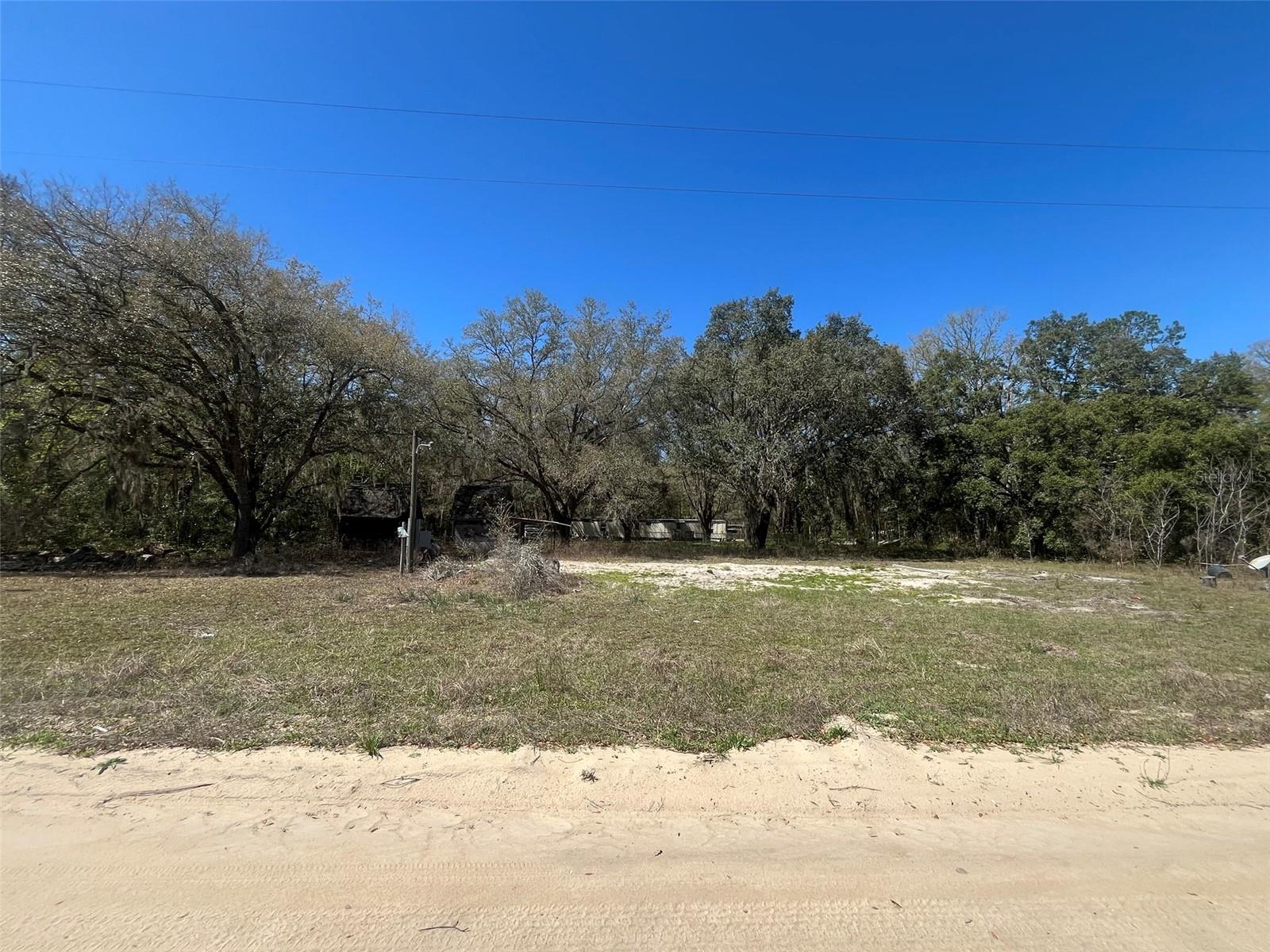 Do not miss out on this 0.43-acre high and dry lot in the growing city of Interlachen. The property includes a septic and well, though their location and functionality are unknown. With power lines already in place, accessing electricity is convenient. Situated within minutes of schools, restaurants, diners, and parks, this lot offers an easy commute to Gainesville or Palatka and is less than an hour from the beach. Investing in land in Florida is a prudent decision for future, whether you plan to build your dream home, a vacation getaway, a rental property, or simply allow the land to appreciate as a valuable long-term asset to resell at a profit in the future.
