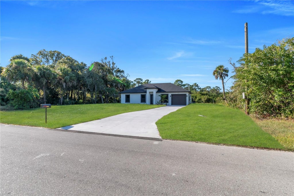 Photo of 644 Woodcrest Dr, Lehigh Acres, FL 33972 (MLS # TB8531856)