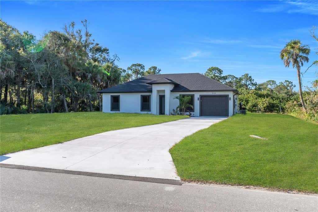 Photo of 644 Woodcrest Dr, Lehigh Acres, FL 33972 (MLS # TB8531856)