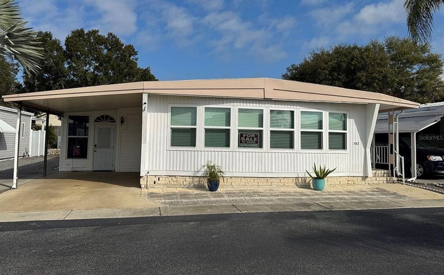 Beautiful home in desired area of Westwind II. Located at a higher elevation in the community. NON flood zone area. Not affected by any of the 2024 hurricanes. Located along fence line providing privacy. Large new paver back patio and retaining wall. Lifetime warranty on Roof over done in 2019. New updates in 2022/2023 include electrical panel, vapor barrier, new sub flooring and luxury vinyl flooring, paved patio, large new front windows, air conditioning and ductwork, dishwasher and garbage disposal. Updated cabinets and hardware. Inside you will find generous sized bedrooms and walk in closets. Not included in the square footage is an additional 300 square feet of air conditioned and heated space that can be used for living room or family room. In the back yard you have an additional 160 square foot attached screened lanai. Storage shed and inside laundry. The community has a beautiful pool and clubhouse. Activities galore. Queen blue bedroom set included with unit. Unit includes an ownership share in the community which gives you a low monthly fee, a voice, and a vote in community affairs. Close to beaches, bike trail, and downtown Dunedin and Palm harbor...