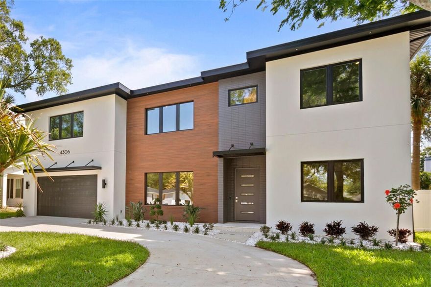 The latest modern development from luxury builder State Street Homes is complete at 4306 W Watrous Ave in Culbreath Heights.  This Mid-Century modern inspired residence has the layout, design and space of a true modern luxury residence.  With 6 beds/4.5 baths/oversized bonus room/ downstairs in-law suite and office this residence blends luxury style with desirable function, all located on an oversized 76’ x 137’ lot with beautiful pool and full outdoor kitchen. The moment you enter this residence you will feel the craftsmanship and attention to detail. This residence has clean lines and wonderful accents, beginning with the FLOATING steel staircase with wood treads and continues with the wire brushed oak HARDWOOD floors that flow throughout the home. The LIVING ROOM has wonderful 10’ high ceilings and expansive 16’ wide sliding glass doors that leads to the massive outdoor space perfect for entertaining. The ceiling height combined with the countless oversized windows brings natural light streaming throughout the home. A center piece of the residence is the GOURMET kitchen with Quantum Quartz Arctic Snow perimeter countertops, encompassing the Cambria Torquay Island with waterfall edging.  The cabinets feature European style flat panel fronts with wrapped white acrylic and rift cut oak as well as slow close and full extension drawers.  The appliances include THERMADOR refrigerator and freeze with paneling, double wall oven, 36” induction range with floating Zephyr hood.  To continue with the fresh modern design the builder has accented with floating oak shelving, designer wave white backsplash, under counter LED lighting and pendant lighting over the island.  This home has butler pantry bar with matching cabinetry and countertops to complement the kitchen, beverage fridge and ice maker, plus an oversized walk-in pantry with complete build-ins. The first level of this residence contains a private in-law suite with full bath, the design allows this bath to also serve as a pool bath.  There is also an additional first floor flexible full sized office/den or 7th bedroom with French doors. The luxury primary suite and bath contains all the look and feel of a European spa; with floating QUARTZ dual vanity, under counter lighting, frameless glass walk-in shower, solid vessel SOAKING TUB, separate makeup vanity and a large 10’x14’ walk in closet. The second level allows maximum living flexibility with a secondary guest bedroom with on-suite bath, as well as two additional guest rooms with attached bath. The second floor provides an oversized 16’x19’ bonus room that can serve as a media/game room, secondary family room or oversized office. The outdoors are just as inviting with a full OUTDOOR KITCHEN, large lanai with tongue and groove ceiling, resort style pool with sun-shelf and spa, plus plenty of greenspace for additional outdoor activities and seating. Additional property features include an expanded 2 car garage, impact windows and doors,  two 16 SEER HVAC systems, radiant barrier roof sheeting, hot water recirculating pump, 8’ solid interior doors, large laundry room, remote video doorbell, pre-wired security, pre-plumb water softener, wired for EV charging and more. You are also conveniently located to Downtown Tampa, Tampa International, I-275 and the Westshore District.  This home is located in the A rated Mabry Elementary, Coleman Middle School and Plant High School boundaries.