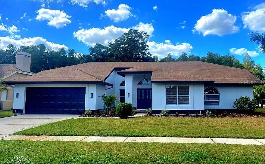 **STUNNING WATERFRONT REMODEL!** If you've been searching for your "DREAM HOME," look no further—this is it! This beautifully updated 2025 home has everything you could want. Nestled in one of the most picturesque neighborhoods along the East Lake corridor, Woodfield is a fantastic community with contemporary Florida homes surrounded by mature trees and serene ponds. Your new home boasts incredible curb appeal with a freshly painted exterior, designer lighting, and vibrant landscaping.  Step inside, and it only gets better! From the moment you enter, you'll be greeted with breathtaking waterfront views. The spacious open floor plan features triple sliders that showcase the scenic vista, while high ceilings enhance the airy and open feel. Professionally staged to display the home's maximum potential!  The dining room includes a stylish accent wall, and the family room is centered around a custom stone fireplace. Windows throughout bring the outdoors in, flooding the interior with natural light. The entire home has been freshly painted and textured, and the brand-new "wood" vinyl flooring is complemented by high baseboards.  The kitchen is a showstopper with a dinette area, a new breakfast bar, stainless steel appliances, sleek soft-close cabinetry, quartz countertops, and a stunning tiled backsplash. All three bathrooms have been upgraded with resort-style finishes, including an incredible glass walk-in shower in the master bathroom. The primary master suite offers a luxurious ensuite and a walk-in closet, while the versatile fourth bedroom can be used as a guest room or home office. Good-sized laundry room with a frosted-glass entry door, cabinetry, and granite counter! 2-car garage with painted garage floor! But the real star might just be the outdoor pool area! The expansive pool deck features a brand-new vinyl ceiling on the covered patio, new brick pavers, and a vaulted screen enclosure. The million-dollar view of the pond and conservation area provides a tranquil setting you'll never want to leave. This home truly has it all!