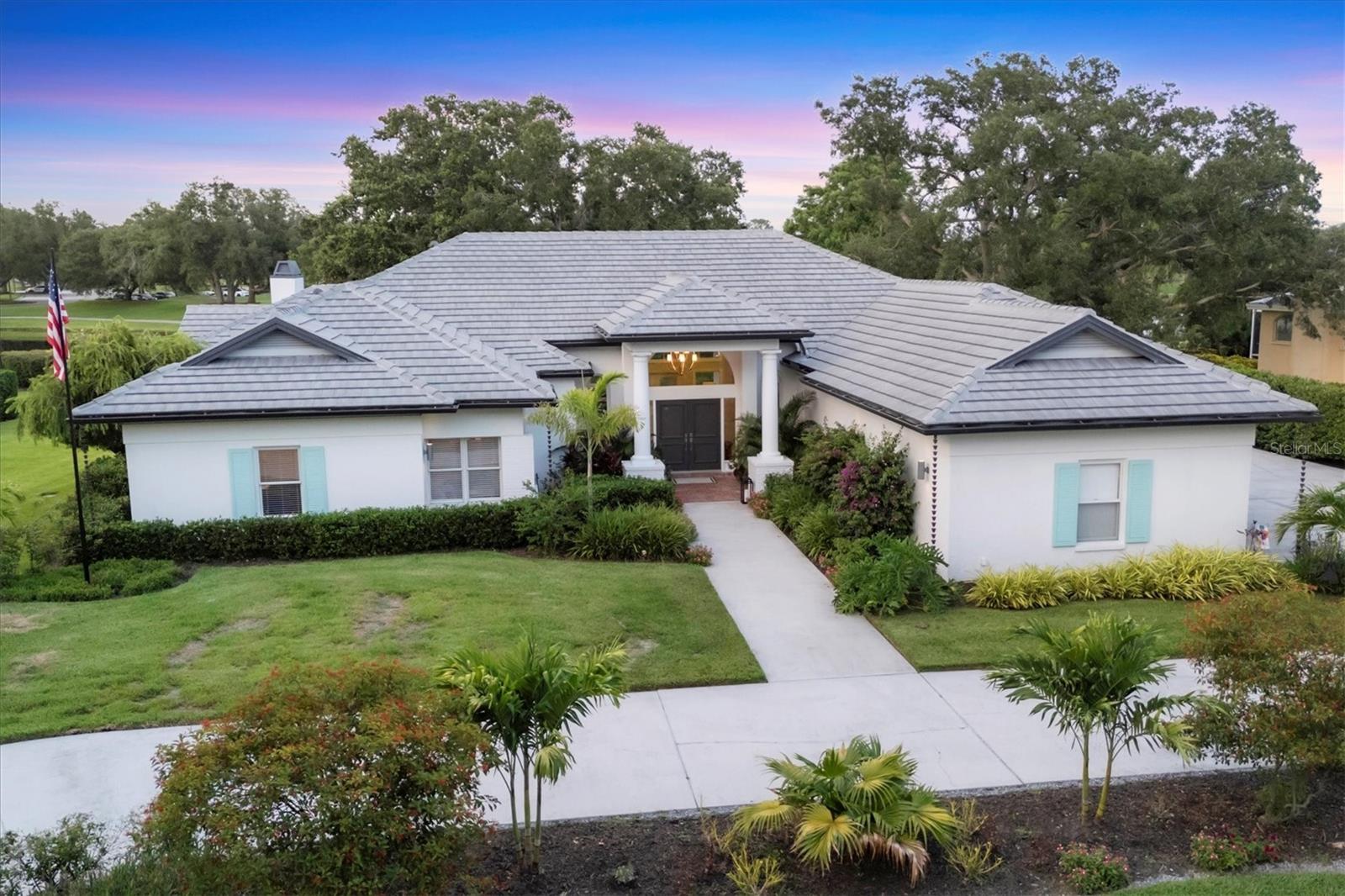 One or more photo(s) has been virtually staged. Experience refined living in this stunning custom estate in Laurel Oak Country Club Estates, one of Sarasota’s most coveted gated communities. Set on a peaceful half-acre lot adorned with majestic oaks and swaying palms, this beautifully renovated 4-bedroom, 4-bathroom home offers over 4125 square feet of modern luxury, architectural charm, and breathtaking views. Soaring vaulted ceilings, custom crown molding, accent tile walls, and designer light fixtures and chandeliers add elegance throughout. The interior has been freshly painted and designed to enhance the natural light that pours in to every room. You will feel the high quality craftsmanship the moment you enter this home; it has been thoughtfully updated to the highest standards. The heart of the home is the stunning 2024 kitchen remodel, featuring Café appliances, quartz countertops, a Brizo touch faucet, instant hot water, under-counter filtration, and a spacious cabinet pantry. Lutron-controlled under and over-cabinet lighting creates an inviting ambiance, perfect for both daily living and entertaining. The expansive primary suite is a private retreat with pool views, two walk-in closets, and a spa-like bathroom with a freestanding soaking tub, oversized shower, and dual vanities. The three generously sized guest bedrooms offer unique details and exceptional comfort. The unique floor plan boasts views of the heated pool from almost every room. The large lanai features a panoramic screen that frames the tranquil lake in the backyard, where deer and birds frequently visit, and an outdoor kitchen with a Lynx built-in grill, drink cooler, custom cabinetry, and matching quartz counters. There is a dedicated pool bath accessible directly from the lanai – all creating an ideal addition for effortless entertaining. This smart home includes a Nest thermostat, security system, smart door locks, programmable irrigation and outdoor lighting, plus a Tesla charger and a 2022 roof for peace of mind. Laurel Oak offers 24/7 guard-gated security, two championship golf courses, tennis and pickleball courts, a junior Olympic swimming pool, vibrant clubhouse, and reciprocal membership with Bird Key Yacht Club. Membership is available but not required. This is a rare opportunity to enjoy the best of Florida living in a truly unique and luxurious home.